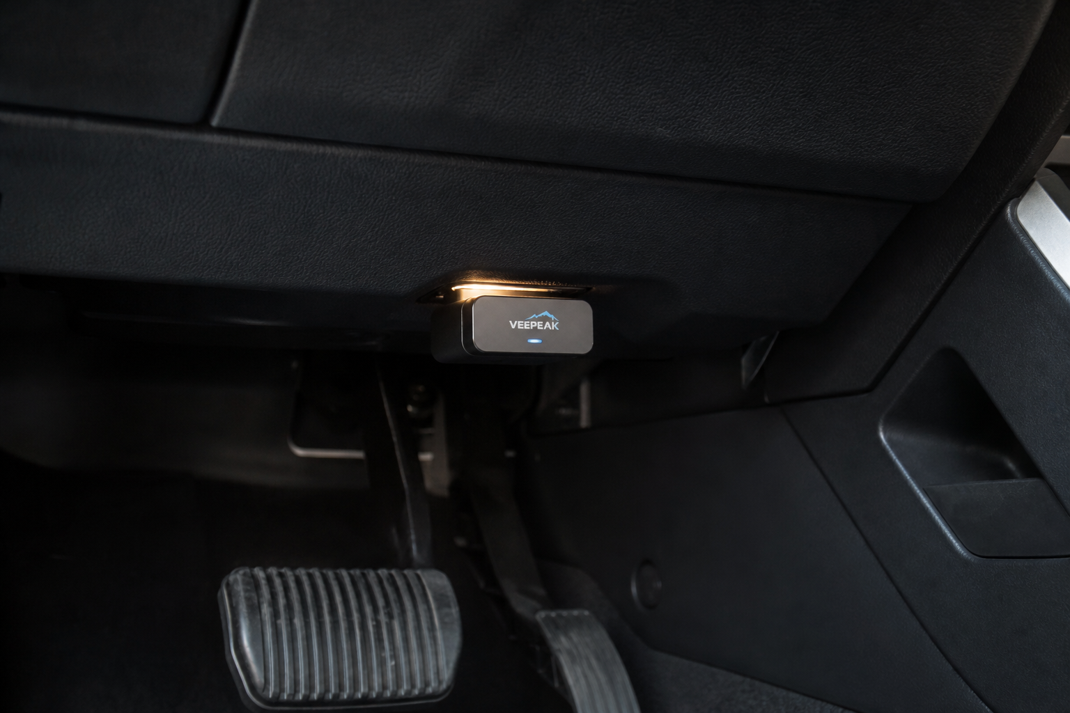 OBD2 module plugged under the dashboard of a Chevy Blazer to permanently disable auto start stop