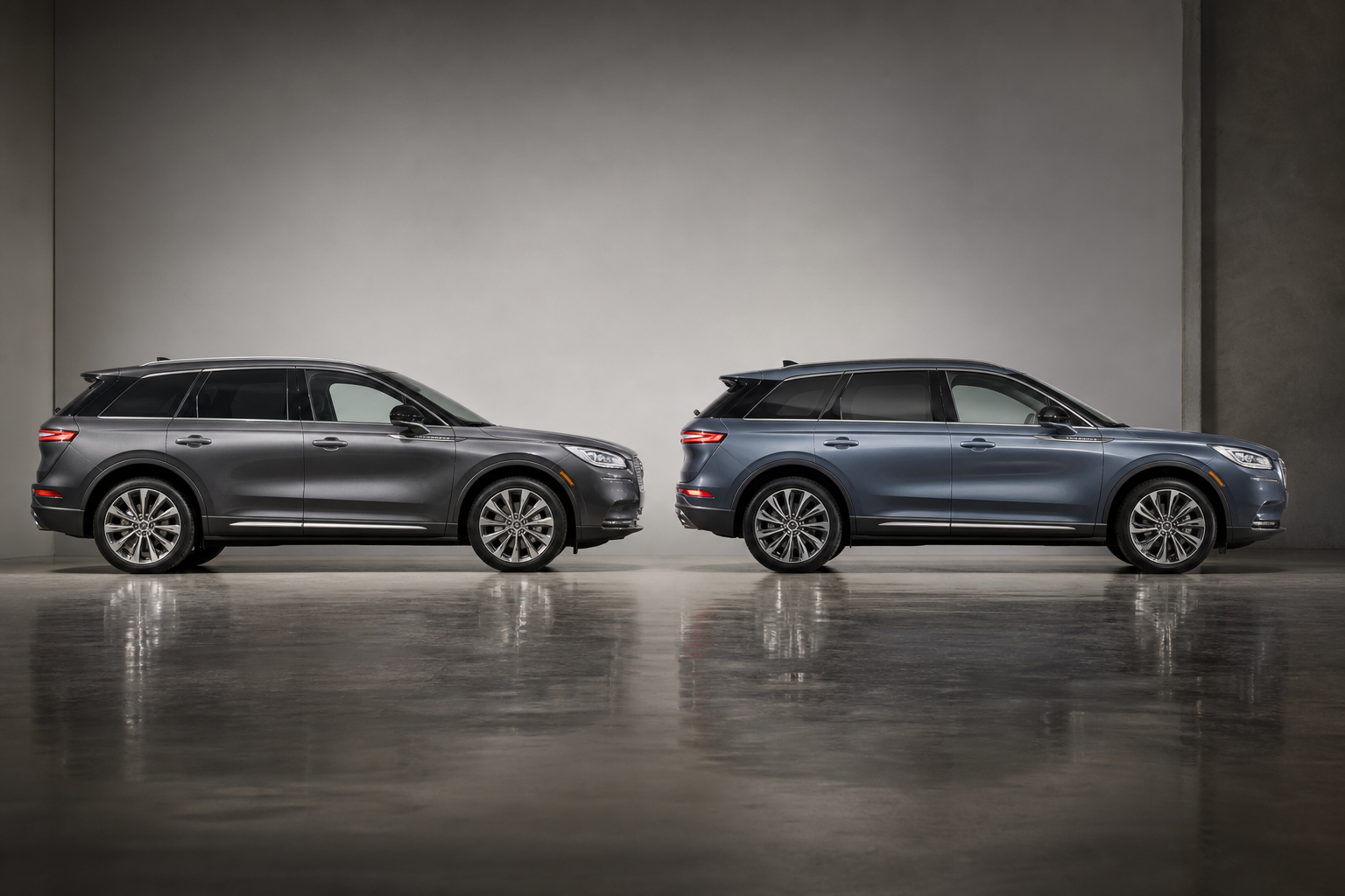 Two Lincoln Corsair SUVs from different model years shown side by side in a studio setting