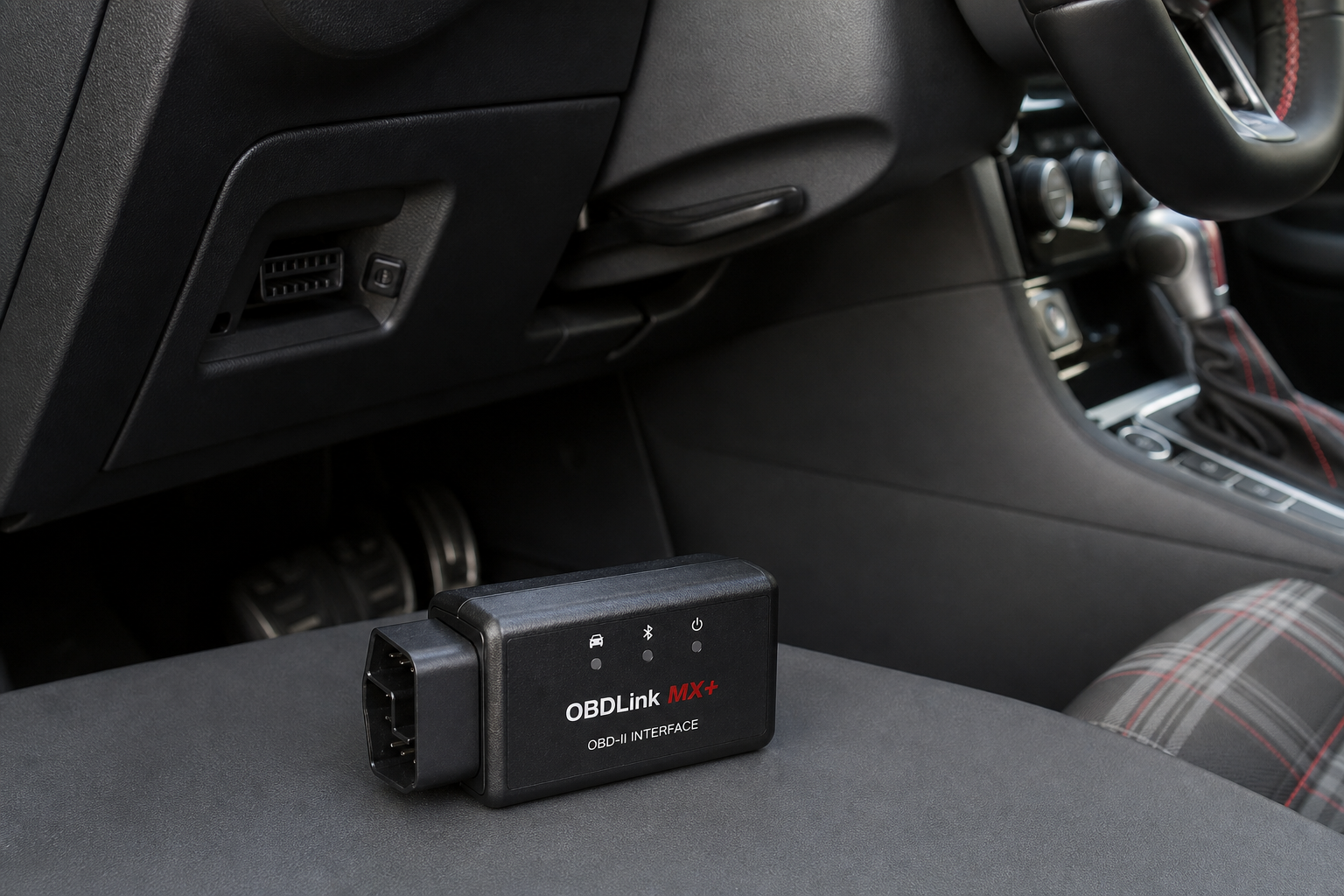 A compact start/stop eliminator module placed near a vehicle OBD2 port under the dashboard