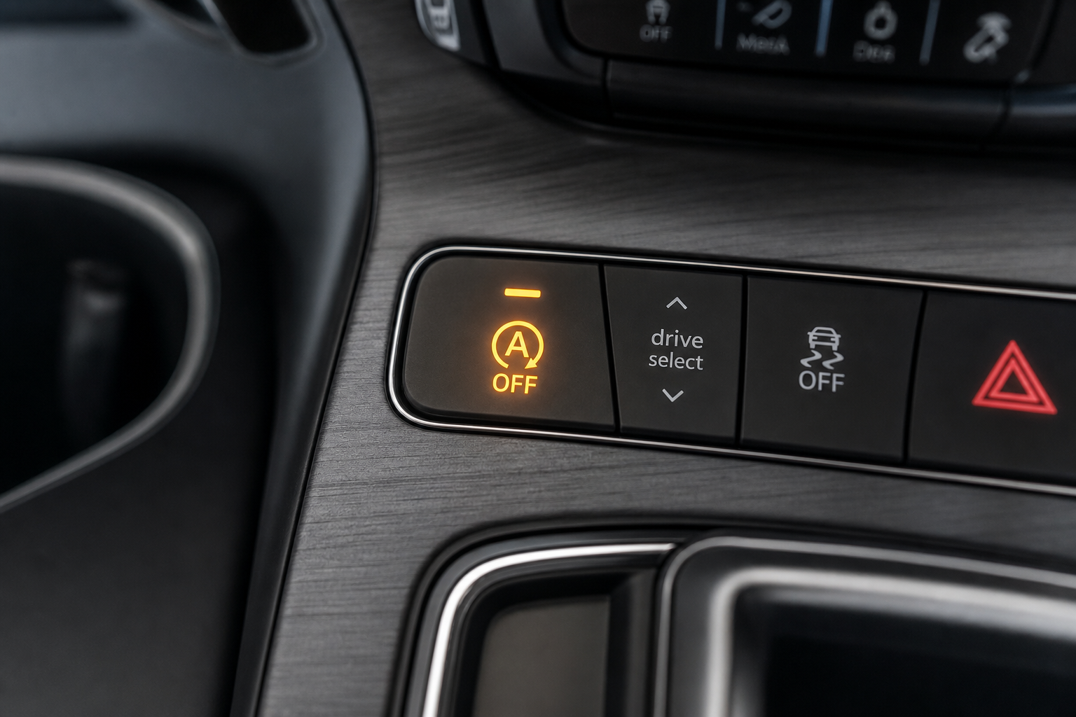 Illuminated auto start-stop disable button on a luxury SUV center console