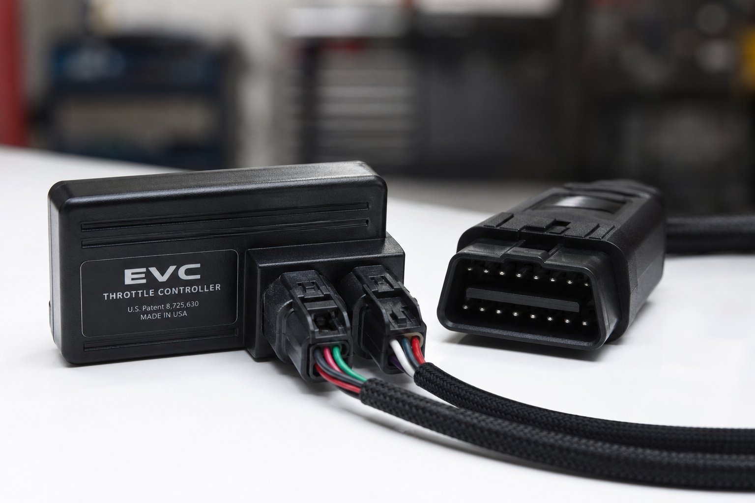 A small black start/stop eliminator module with wiring connectors on a clean surface