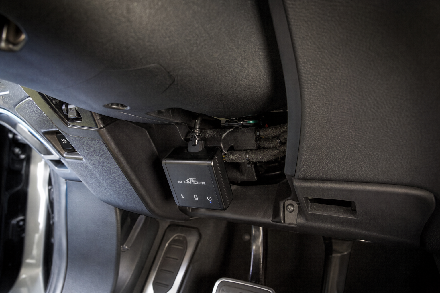 Small automotive plug-in eliminator module installed under the dashboard of a Mercedes-Benz GLC