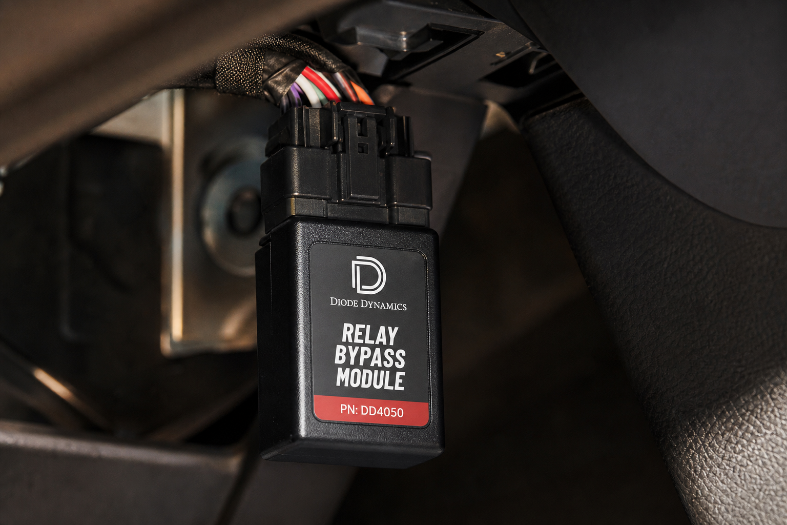 ISG eliminator module plugged into a vehicle wiring connector under the dashboard