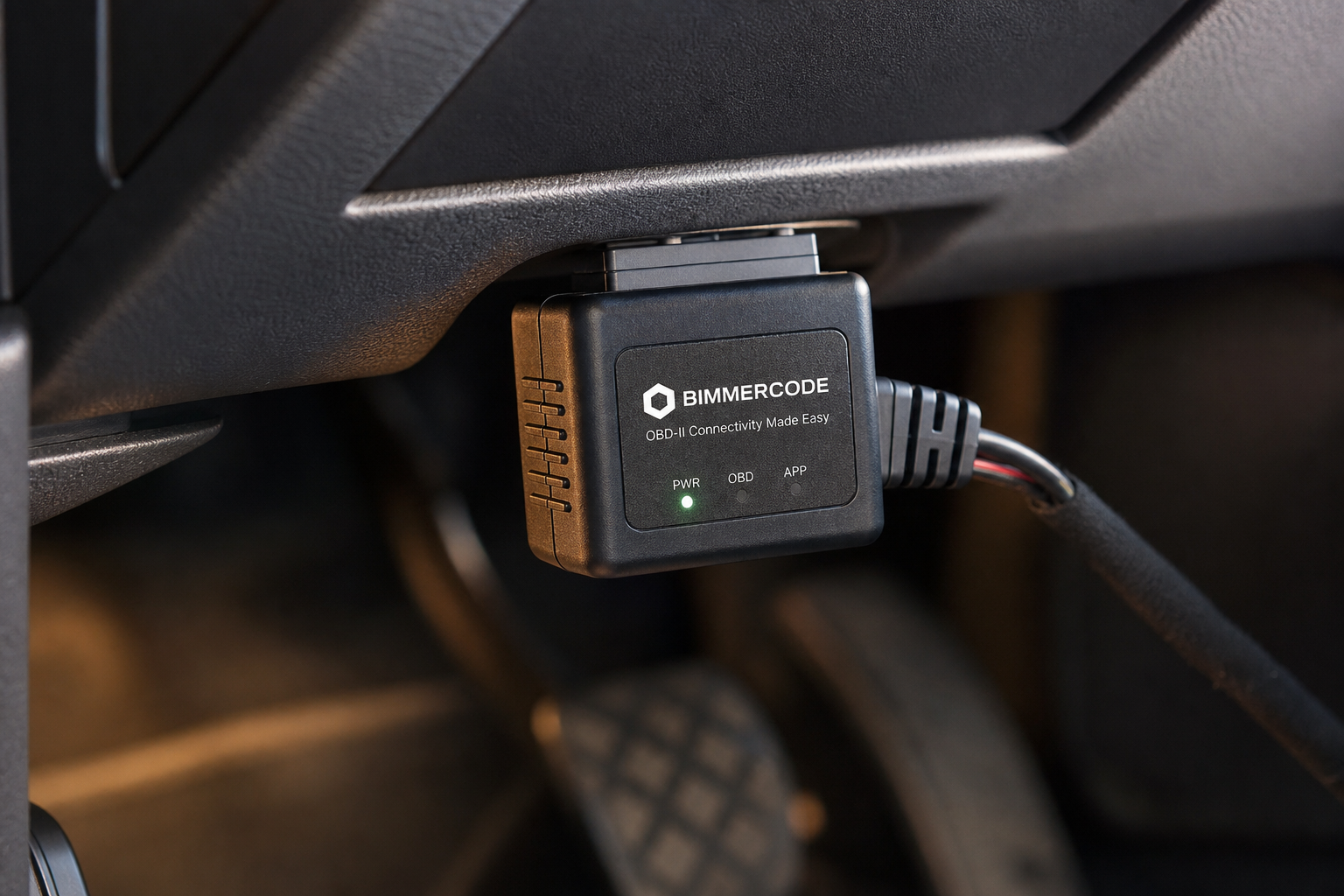 ISG eliminator module plugged into a car's OBD2 port under the dashboard
