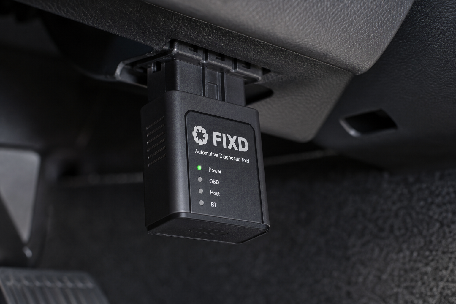 Start/Stop eliminator module plugged into a vehicle wiring connector under the dashboard
