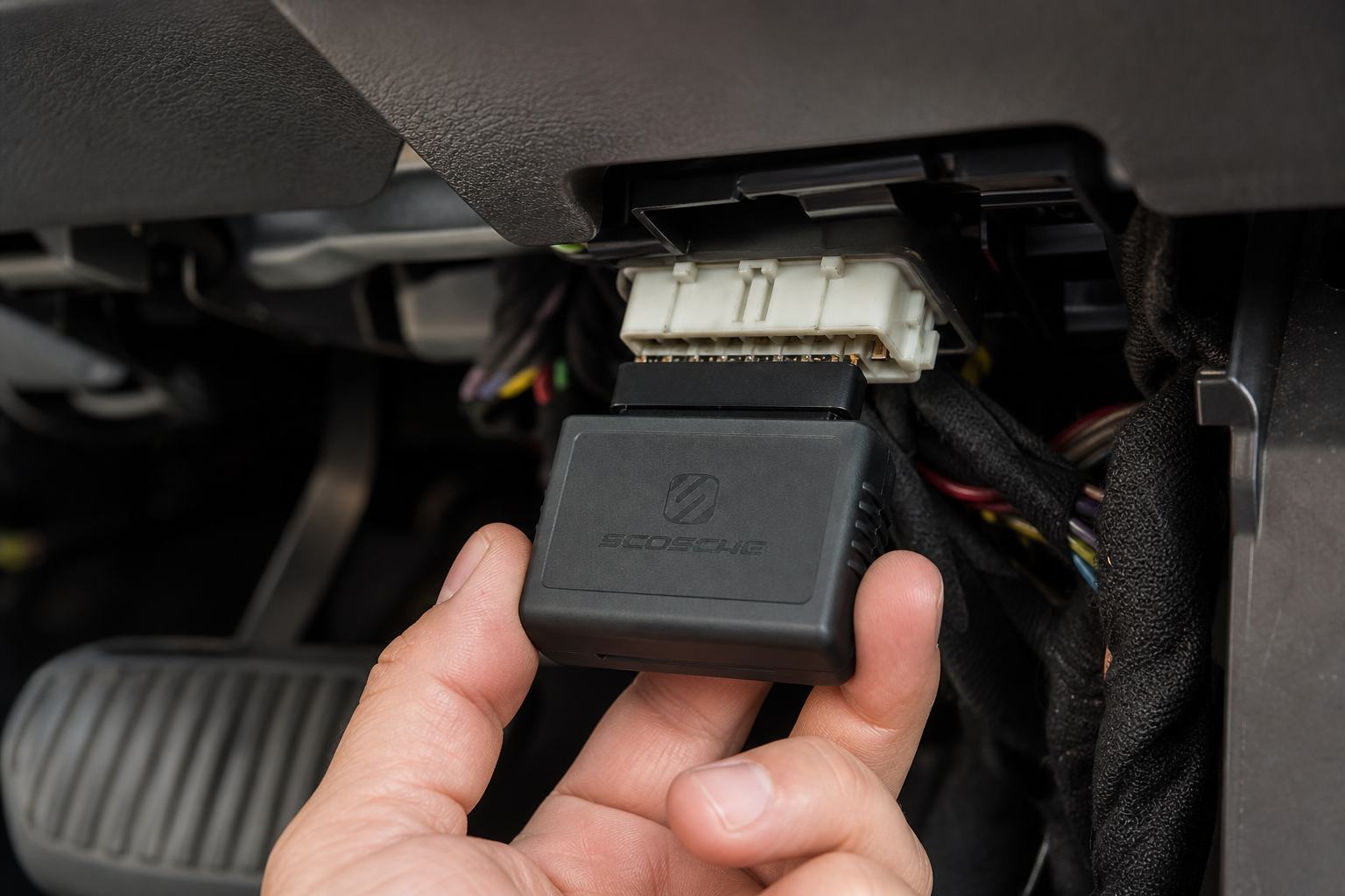 A plug-and-play auto start-stop eliminator module being connected to a car wiring harness