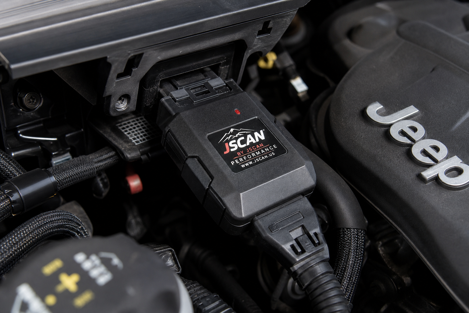 Plug-and-play auto start stop eliminator module connected to a vehicle wiring harness in an engine bay