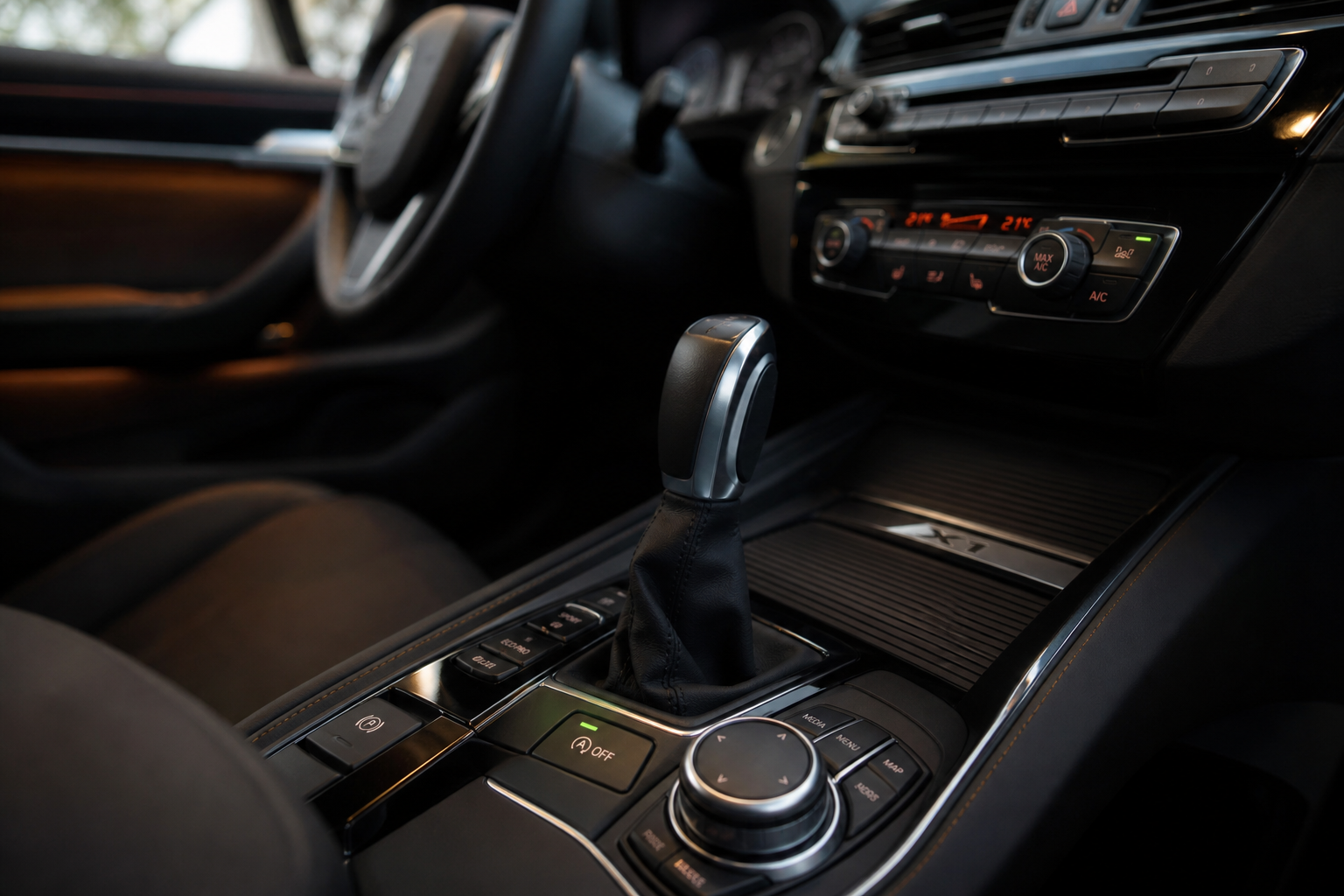 Close-up of the auto start/stop button on a BMW X1 center console