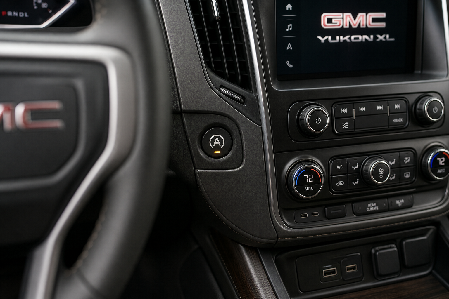 Close-up of the auto start/stop disable button on a GMC Yukon XL dashboard