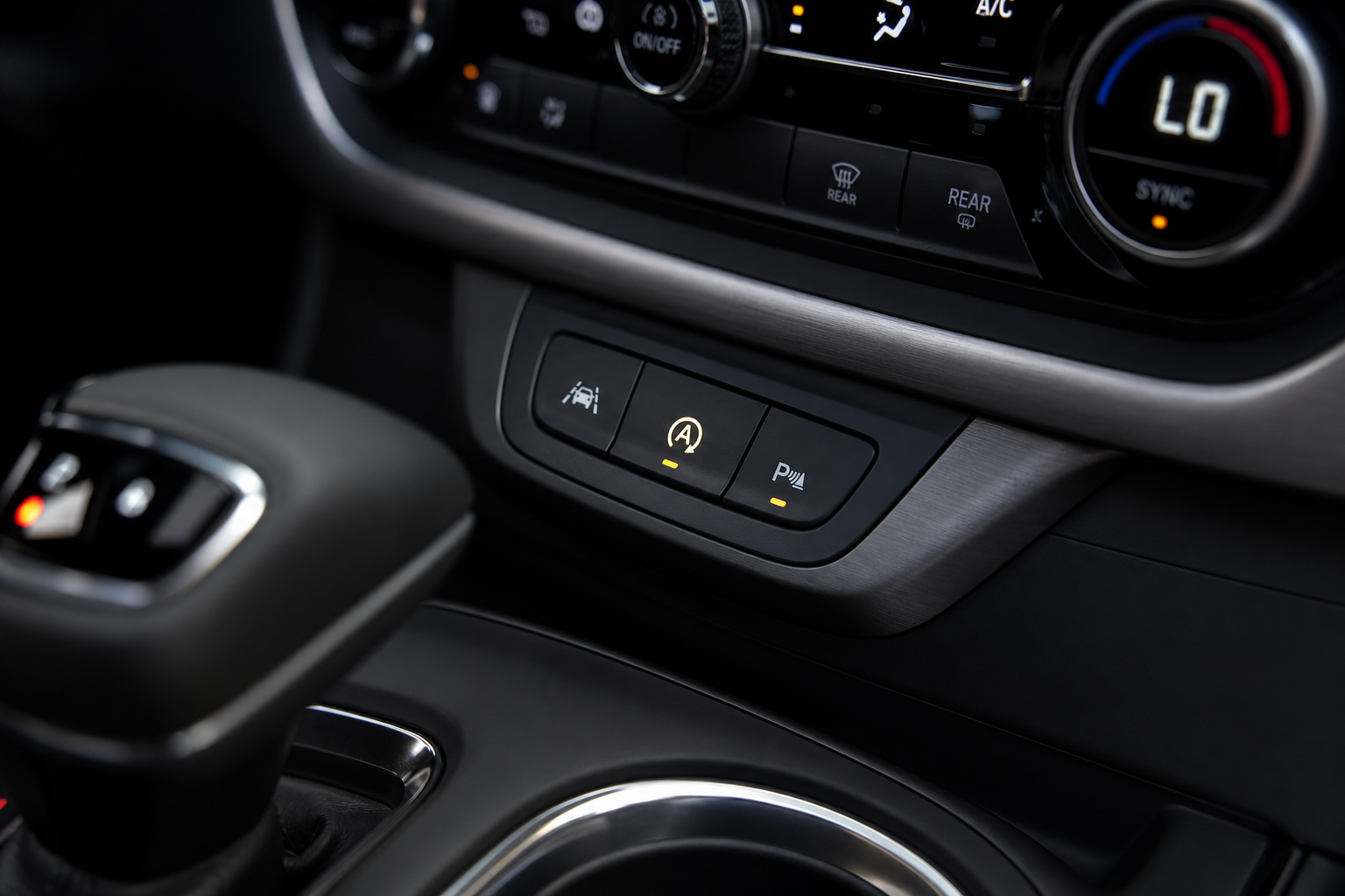 Close-up of the Auto Start Stop disable button on a Chevy Blazer center console