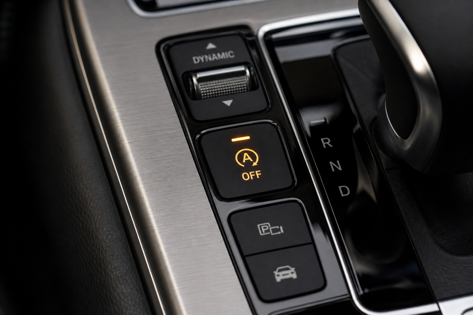 Close-up of the auto start/stop A/OFF button on a luxury SUV center console