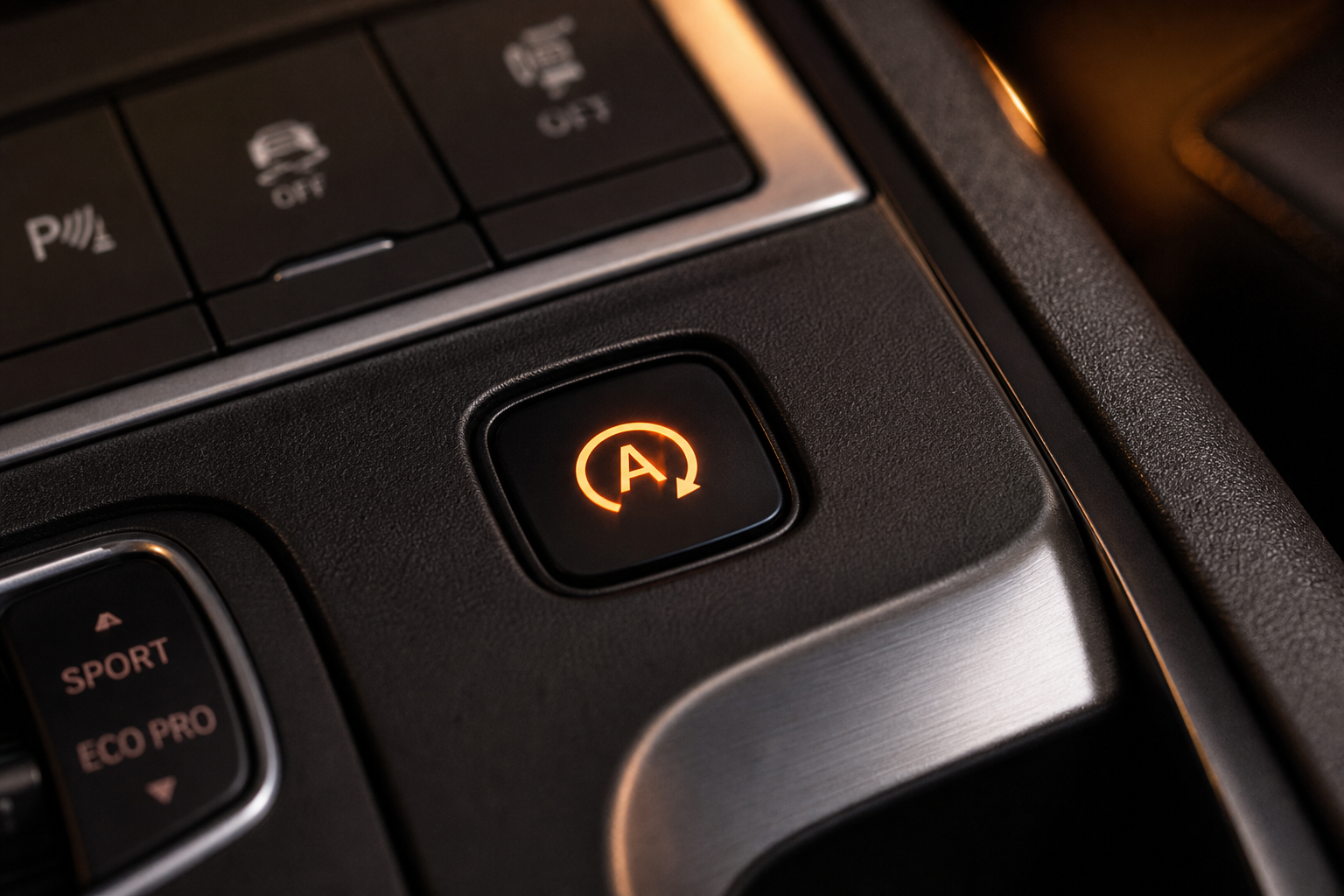Close-up of the auto start-stop button on an Acura RDX center console