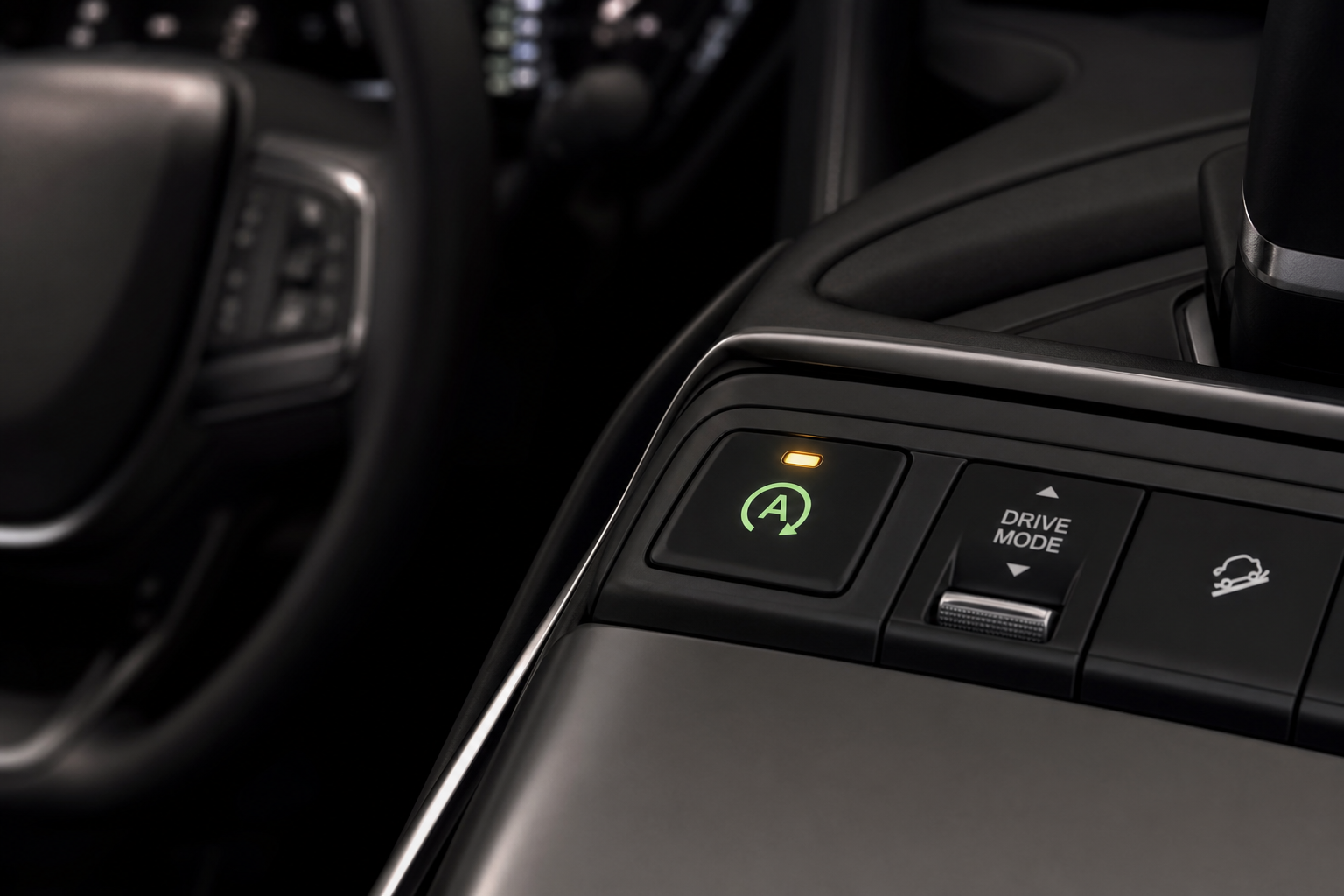 Close-up of the auto stop/start button on an Acura MDX center console