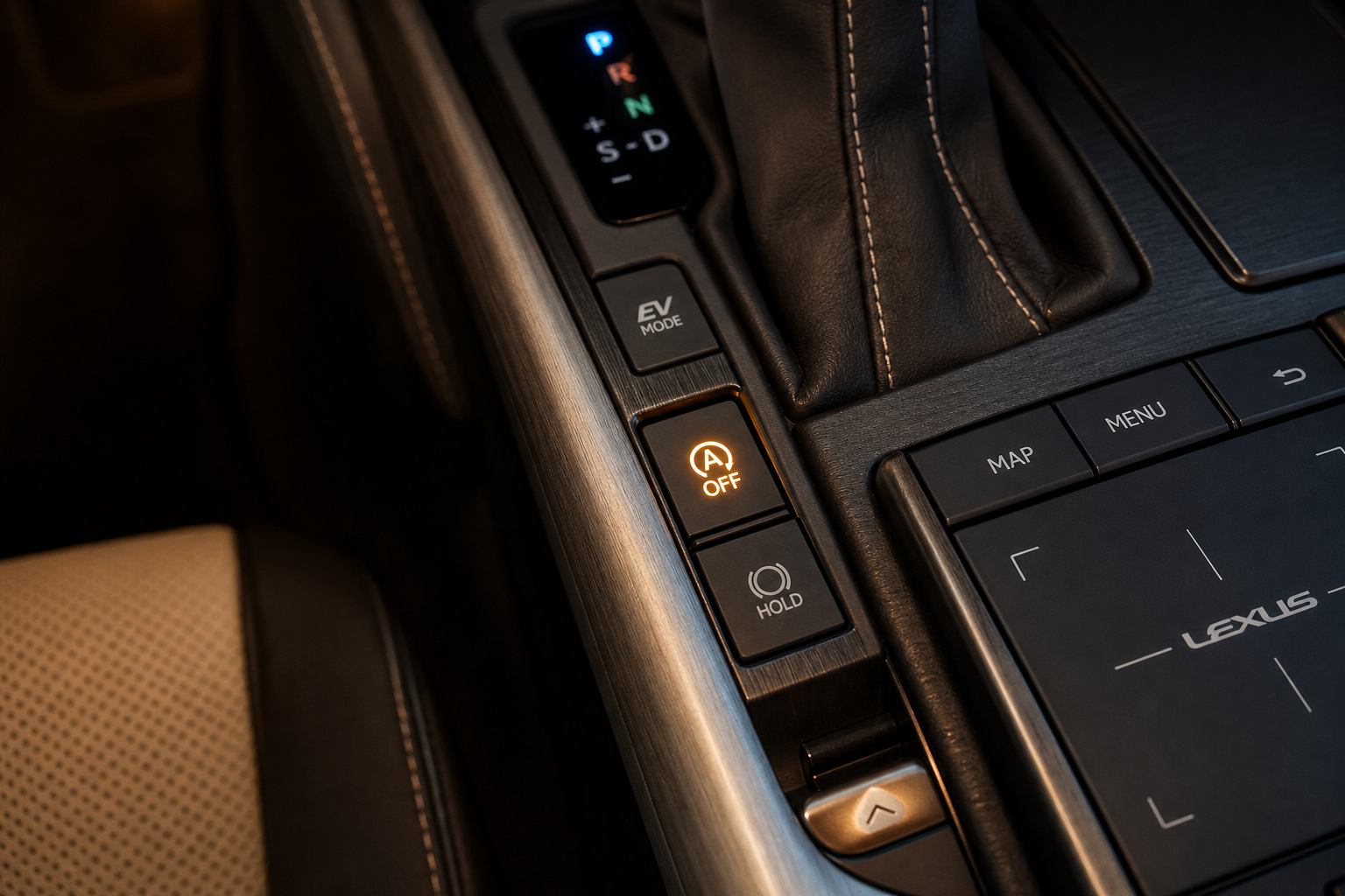 Close-up of the auto start/stop disable button on a Lexus ES center console