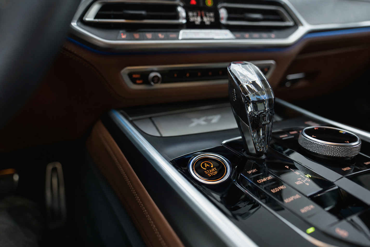 Close-up of the auto start/stop button on a BMW X7 dashboard