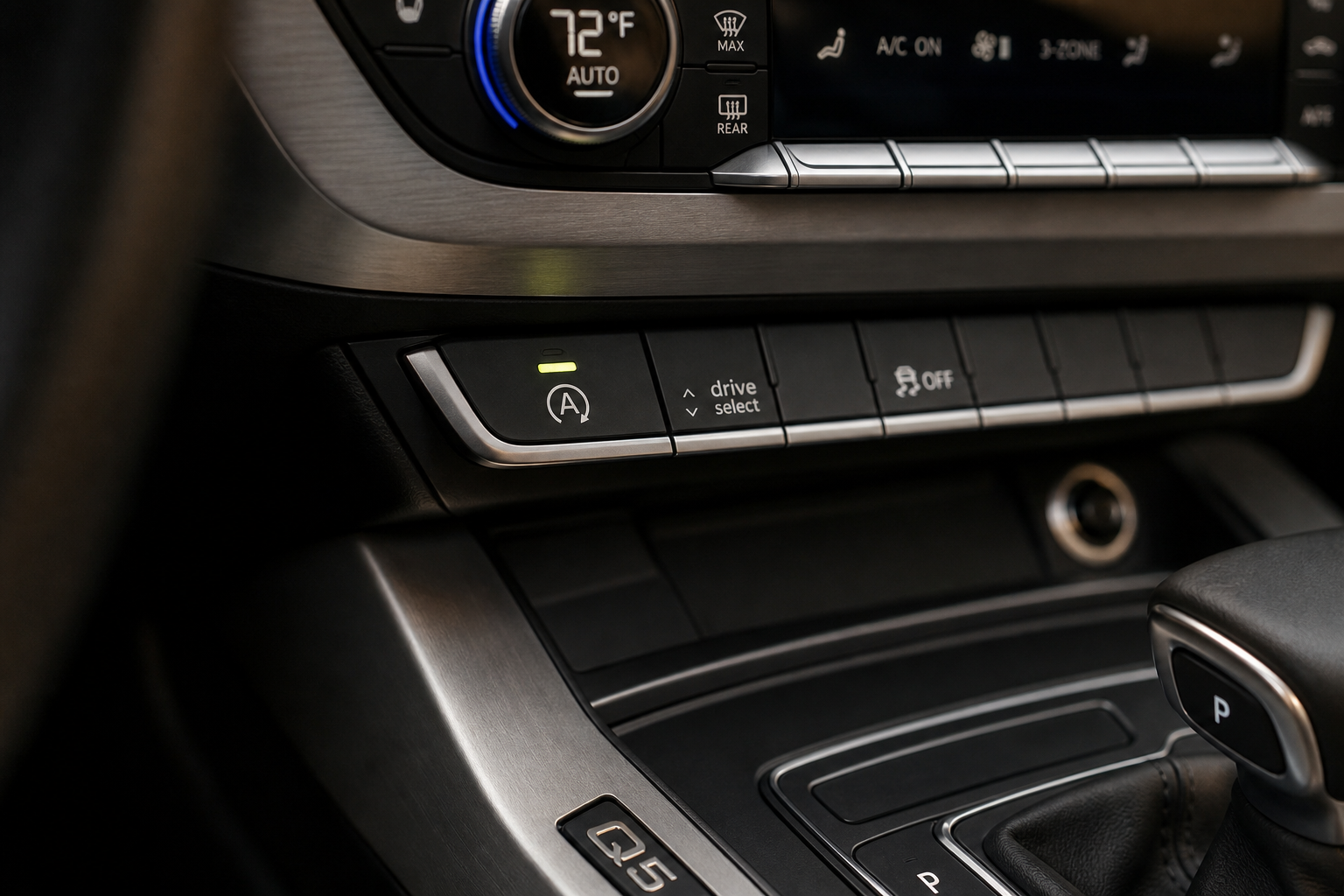 Close-up of the Auto Start/Stop button on an Audi Q5 dashboard center console