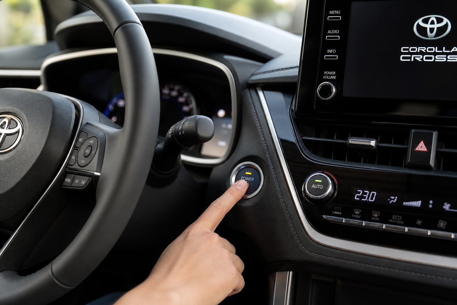 Finger pressing the auto start/stop button on a Toyota Corolla Cross dashboard