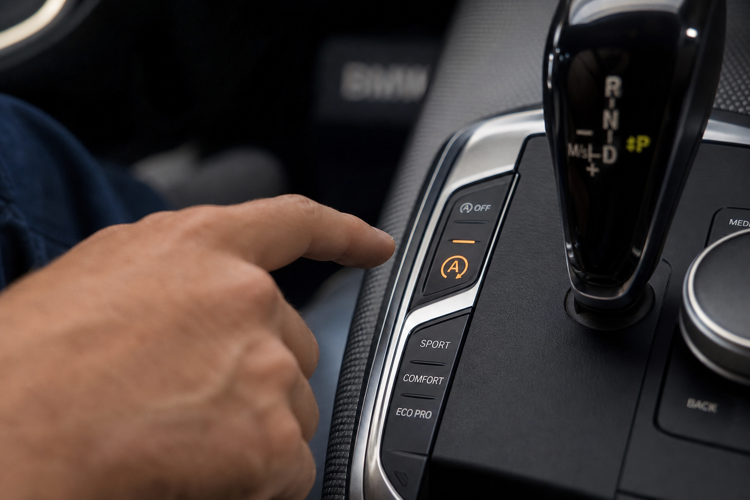 BMW 3 Series auto start/stop dashboard button glowing on the center console