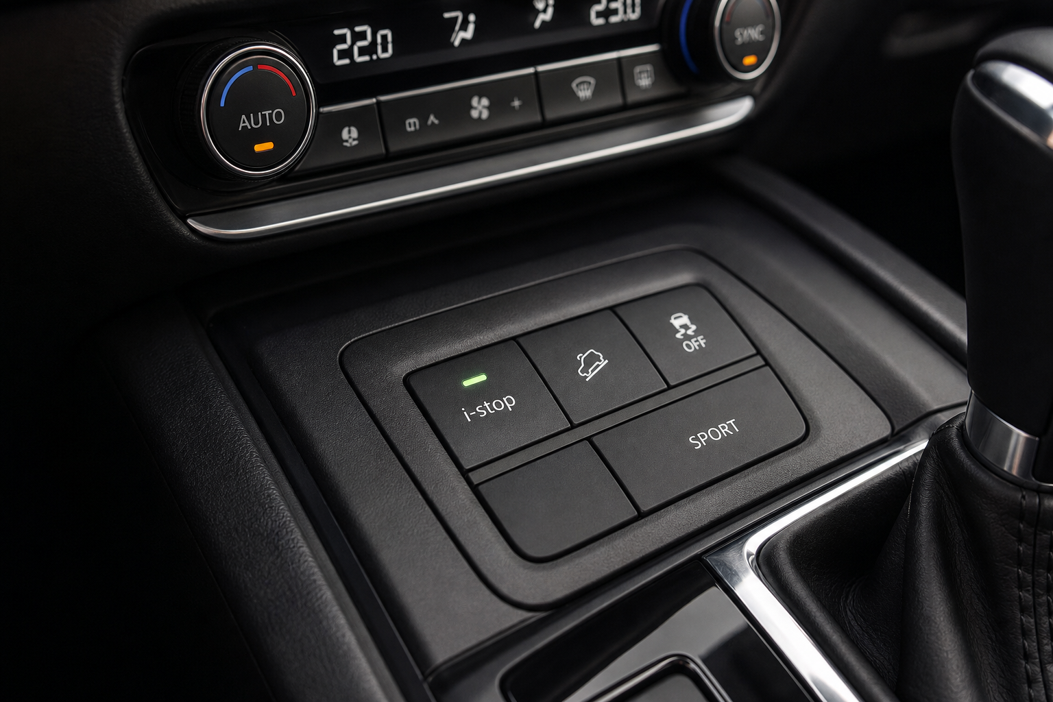 Illuminated i-stop auto start-stop button on a Mazda CX-30 center console