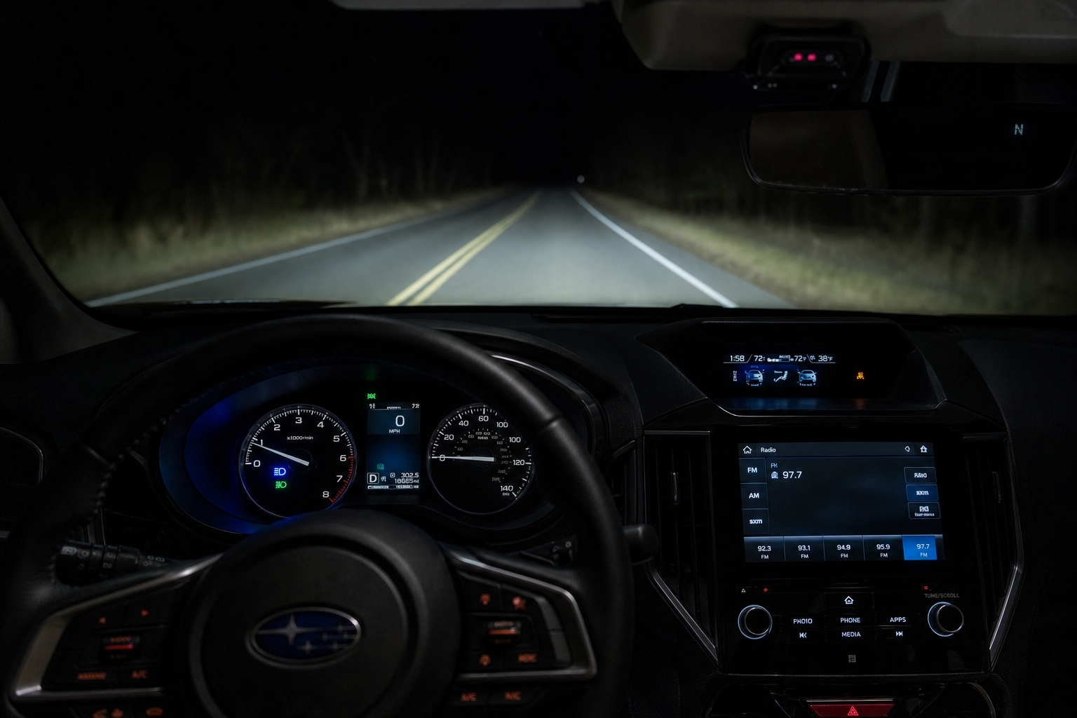 Subaru Forester dashboard showing automatic headlight and high beam assist indicators at night