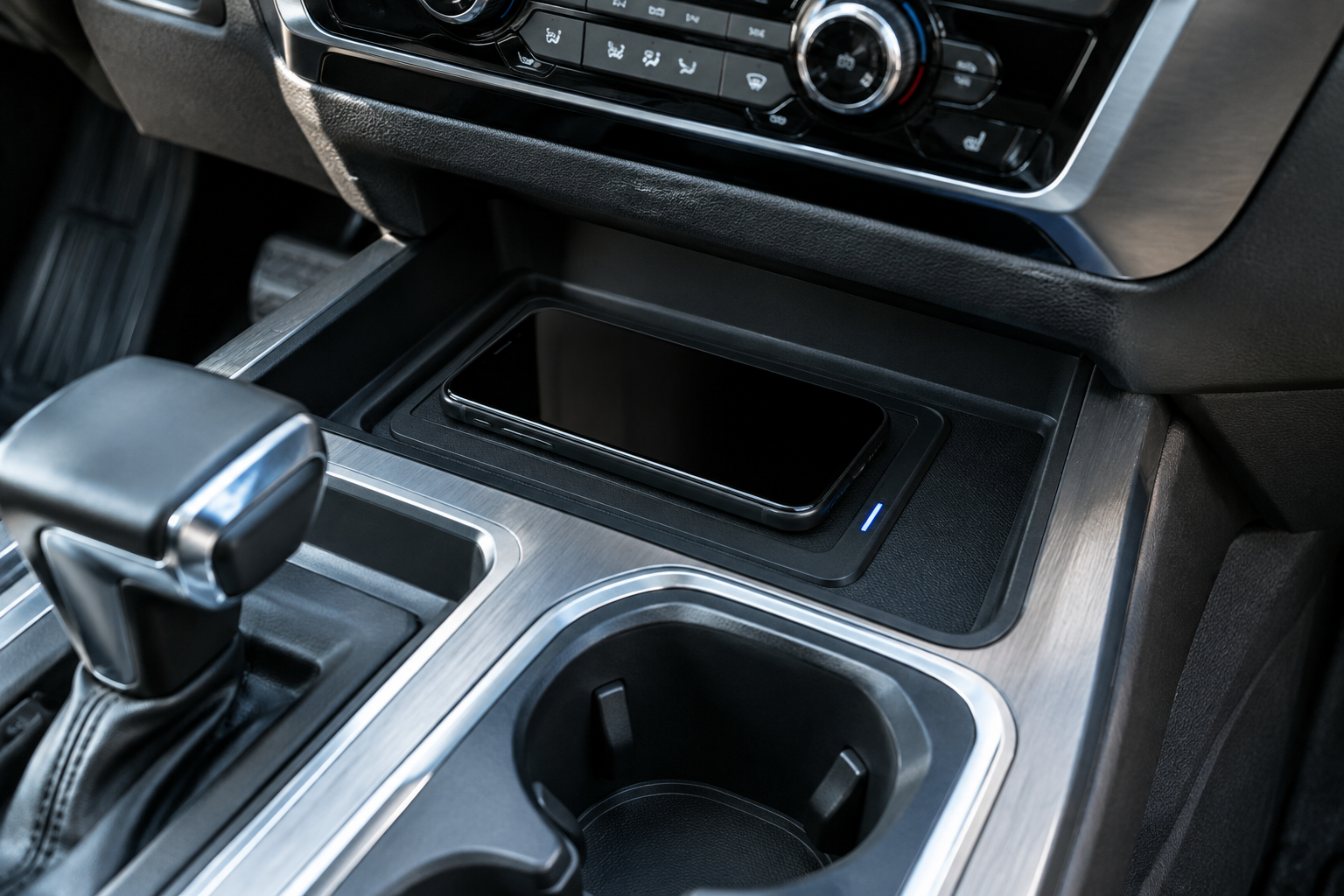 Close-up of a smartphone on the wireless charging pad in a Chevy Silverado 1500 with indicator light visible