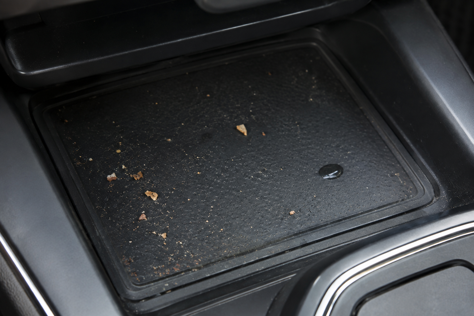 Dirty and dusty car wireless charging tray with debris