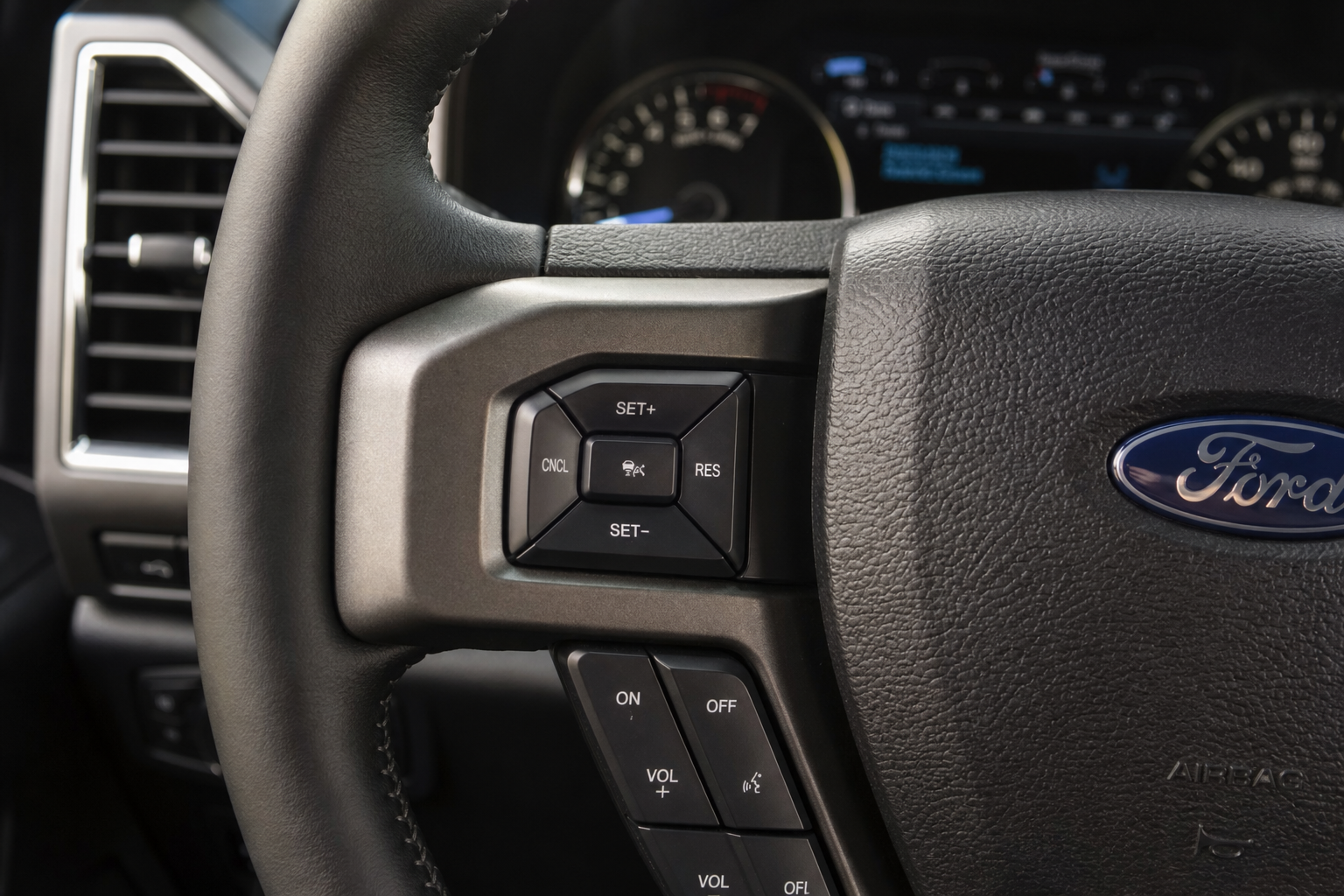Close-up of Ford F-150 steering wheel showing cruise control buttons