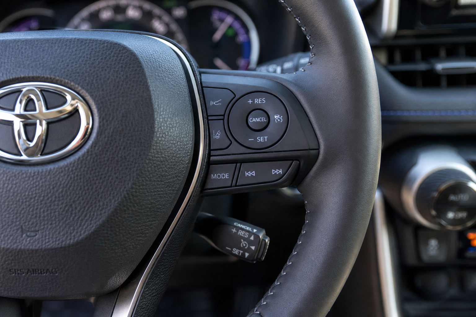 Close-up of Toyota RAV4 steering wheel showing cruise control buttons