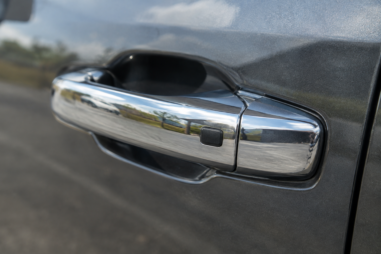 Close-up of a GMC Sierra 1500 door handle with a capacitive touch sensor