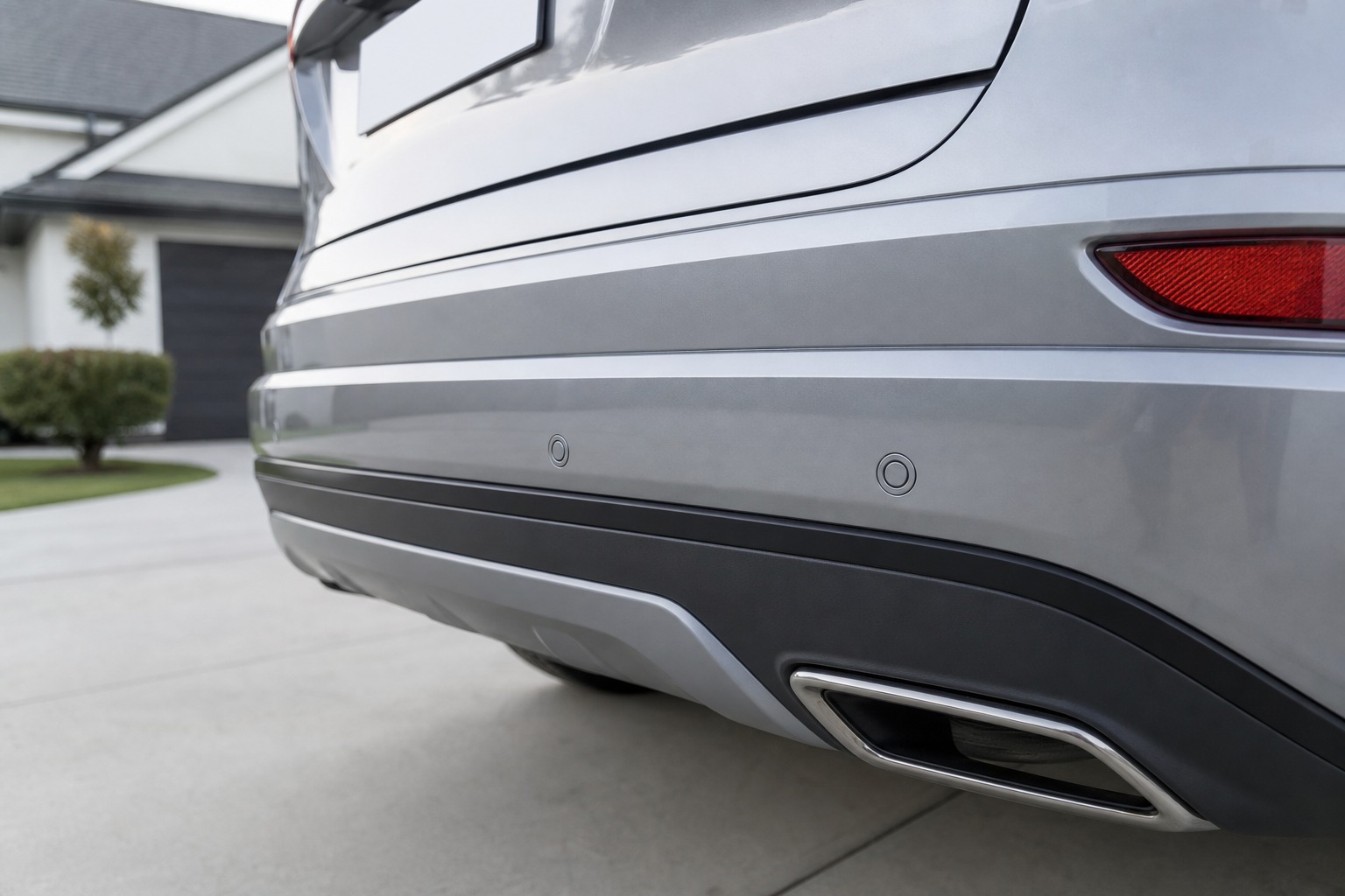 Close-up of rear parking sensors embedded in an SUV bumper