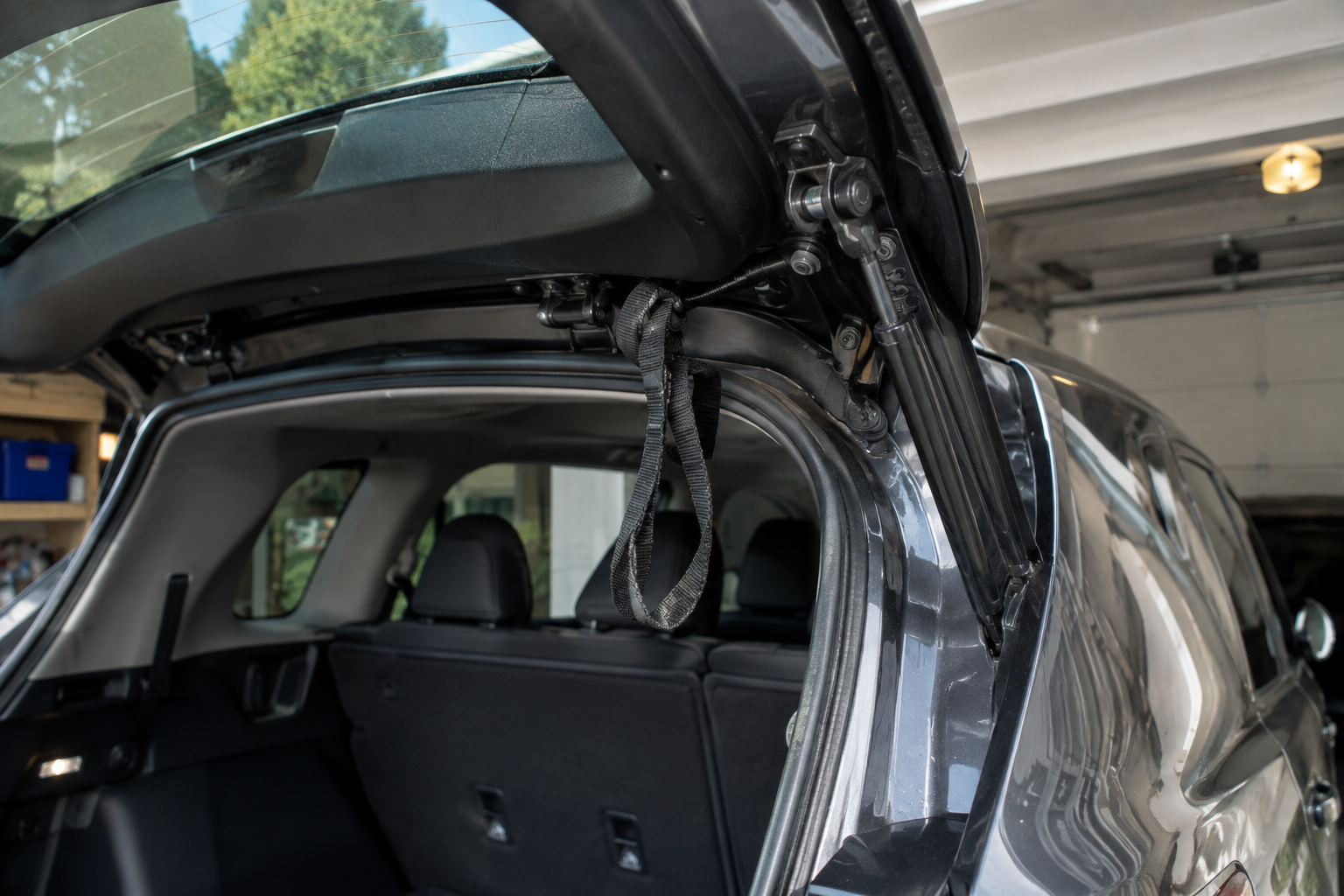 Close-up of a power liftgate mechanism with an object causing an obstruction