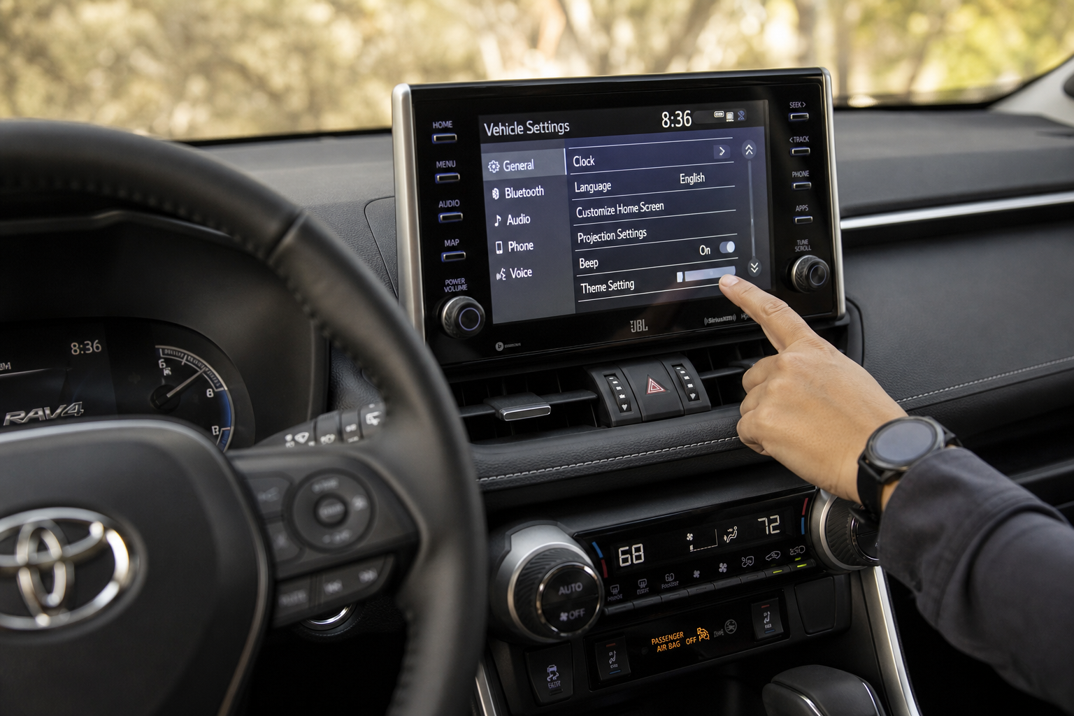 Driver adjusting settings on a Toyota RAV4 touchscreen infotainment system