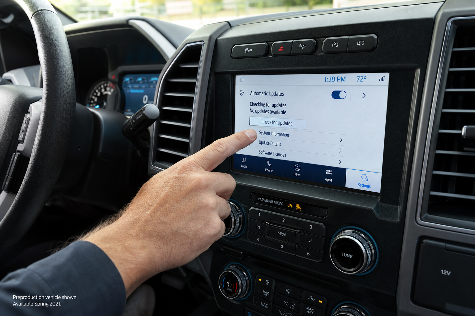 Driver's hand pressing the Ford F-150 infotainment screen to reset system settings