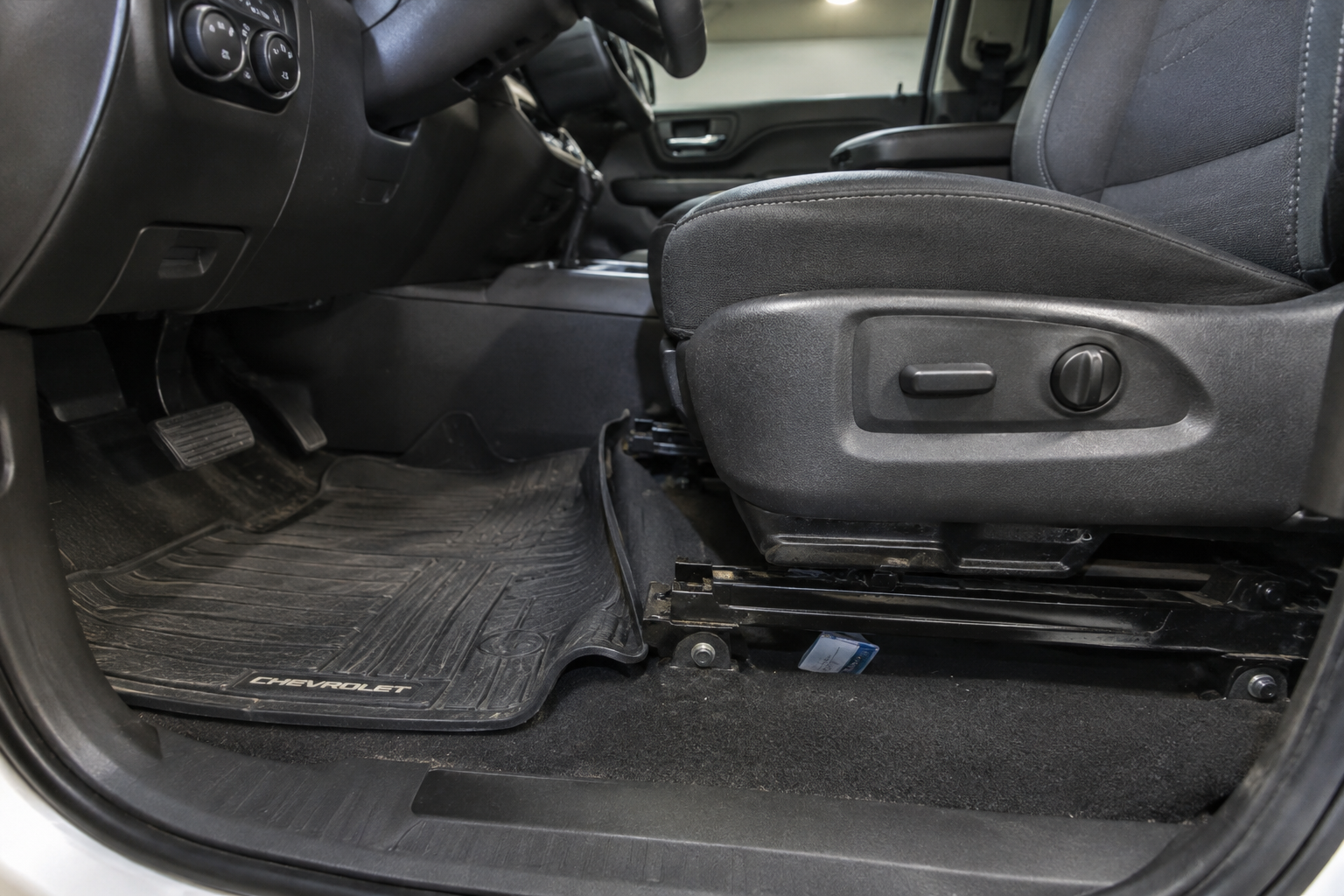 Truck seat rail with a floor mat obstruction blocking full seat travel
