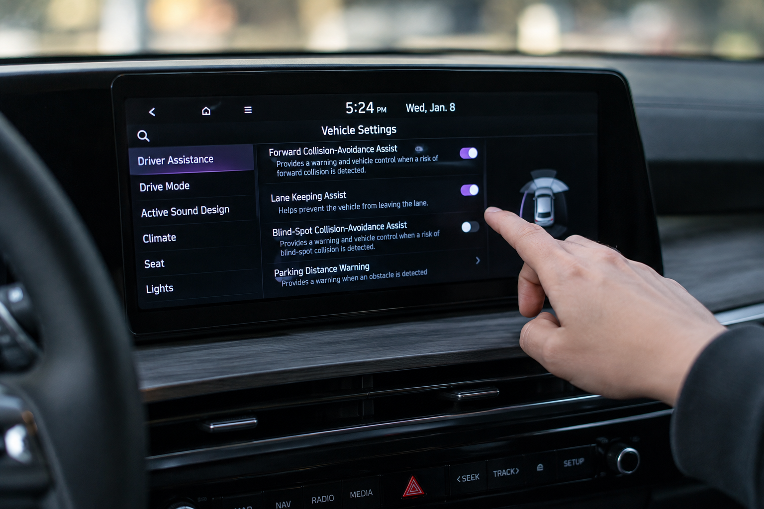 Driver adjusting vehicle settings on Kia Telluride touchscreen infotainment system