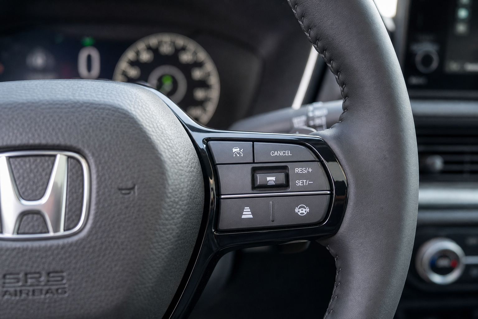 Close-up of Honda CR-V steering wheel adaptive cruise control buttons