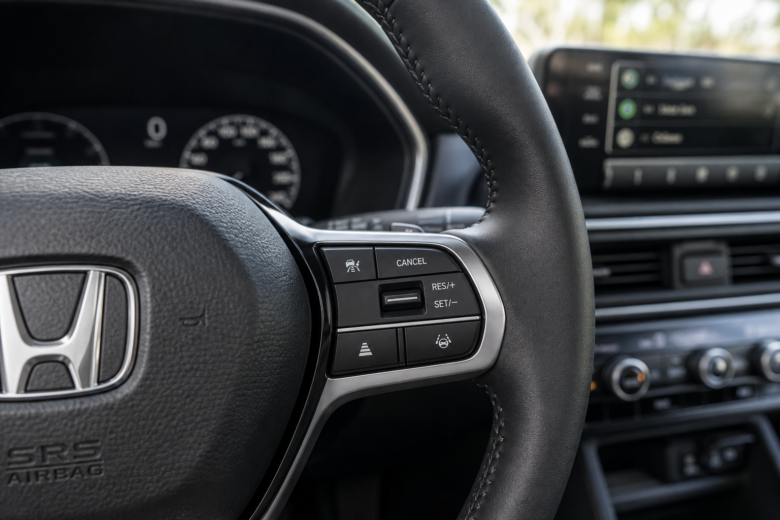 Close-up of Honda Pilot steering wheel conventional cruise control buttons