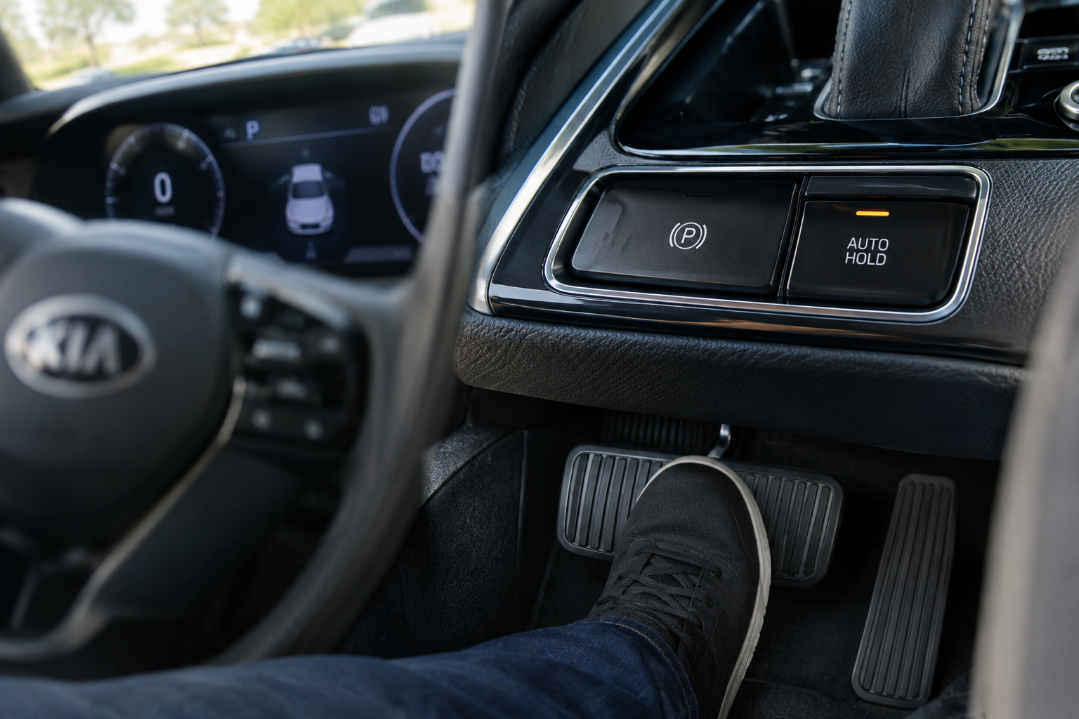 Close-up of Kia Sportage brake pedal and Auto Hold button showing engagement conditions
