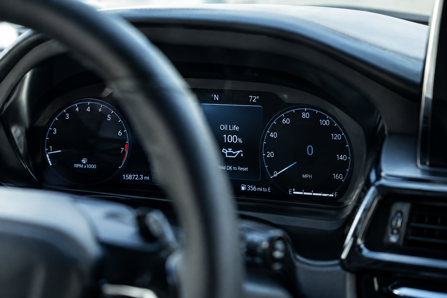 Car dashboard display showing digital oil life monitor percentage