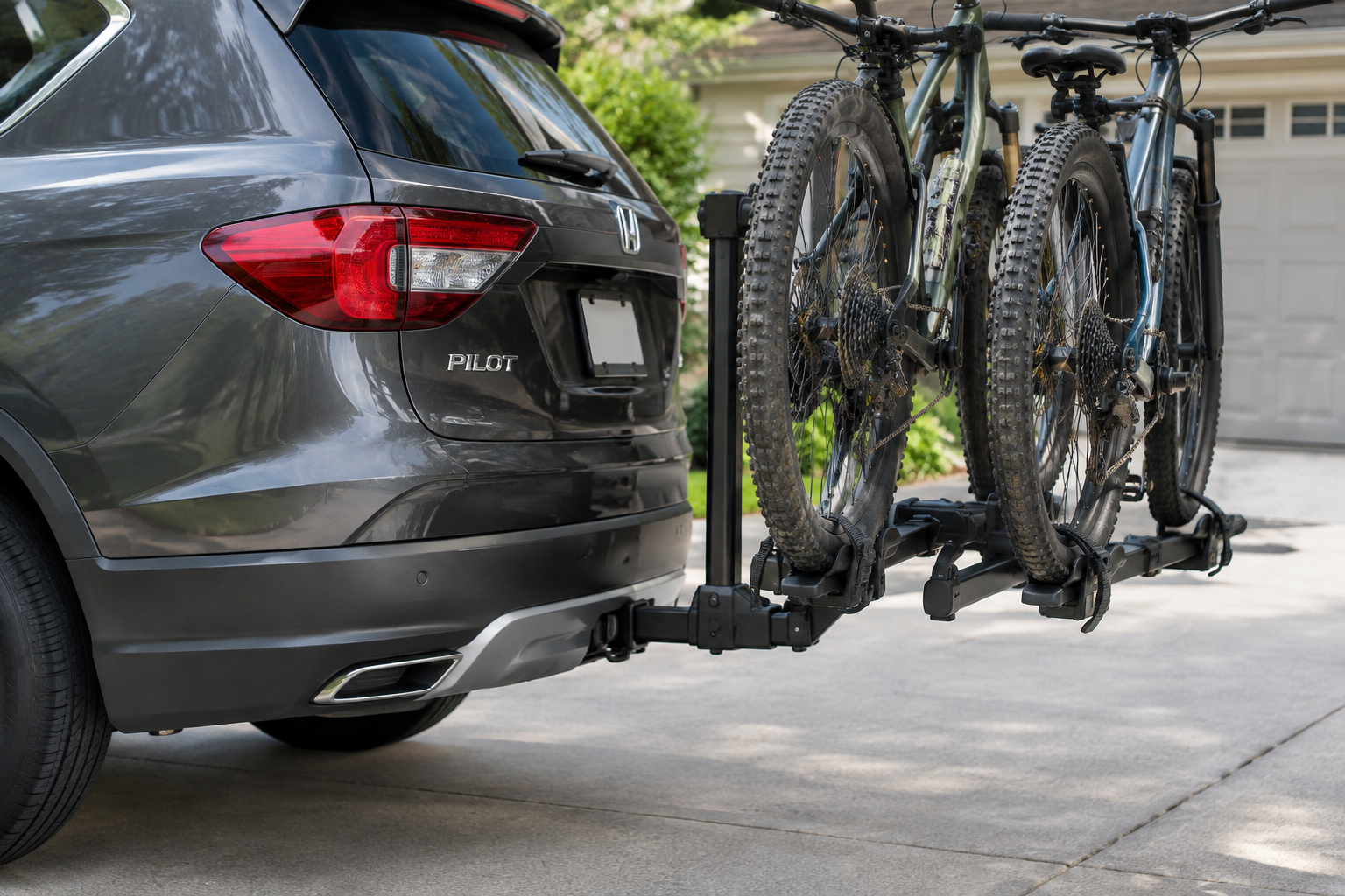 Honda Pilot with a tow hitch and bike rack mounted near rear parking sensors