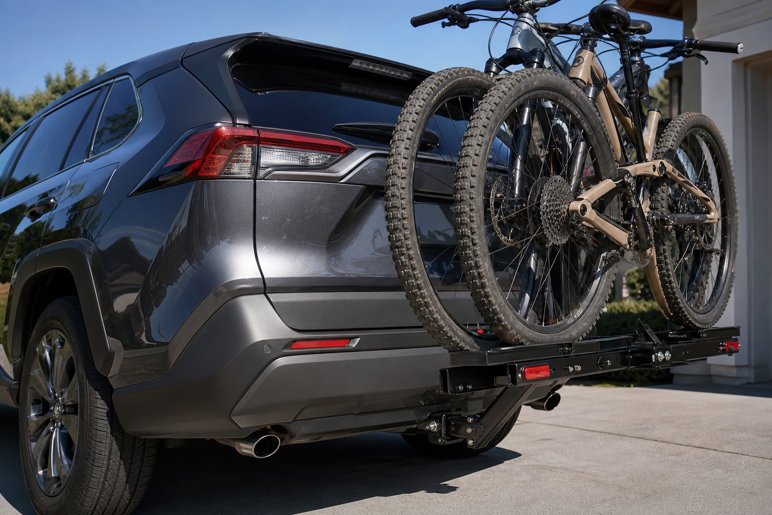 Toyota RAV4 with a tow hitch and bike rack installed near the rear parking sensors