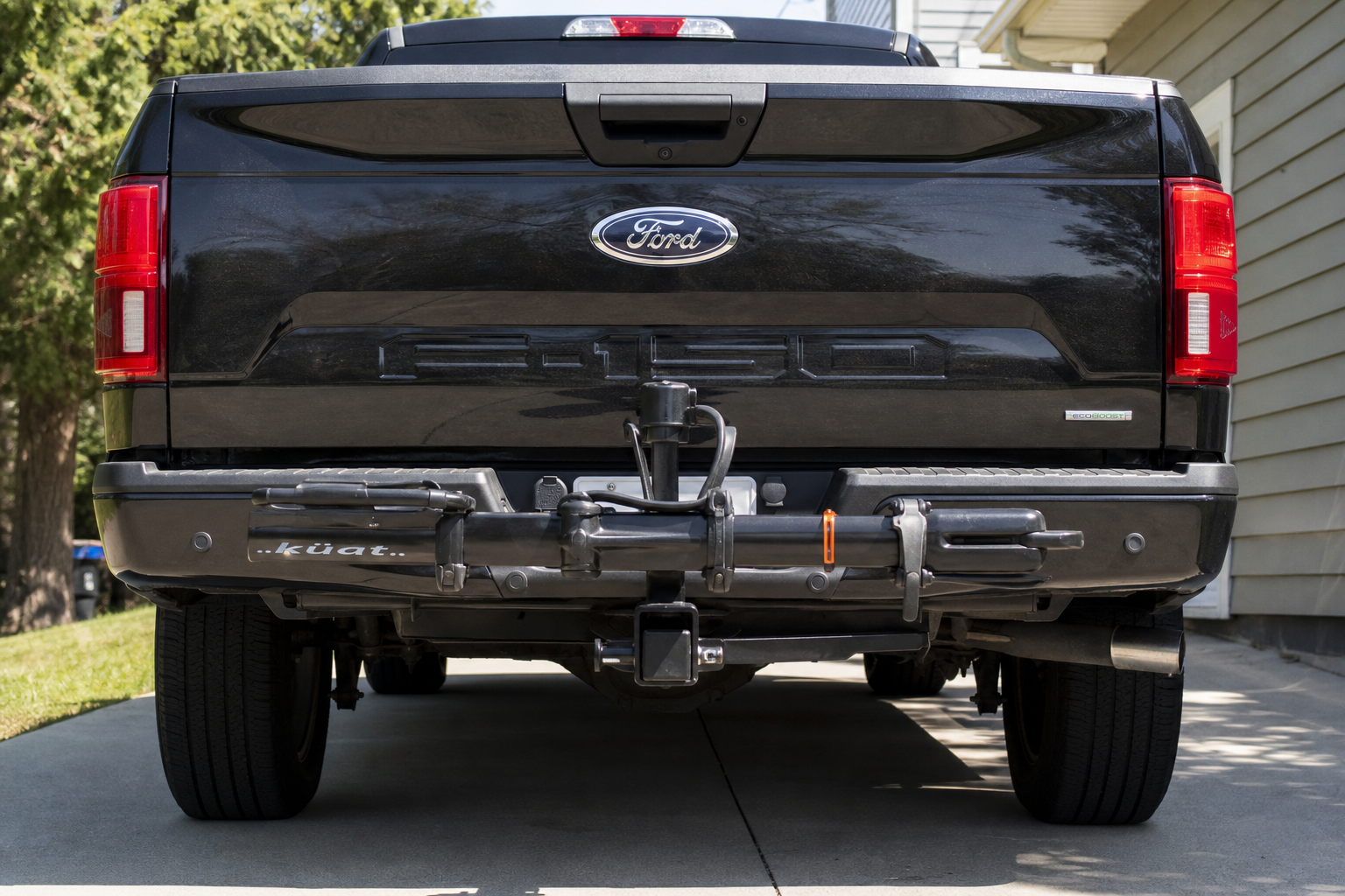 Ford F-150 rear bumper with tow hitch and bike rack near parking sensors