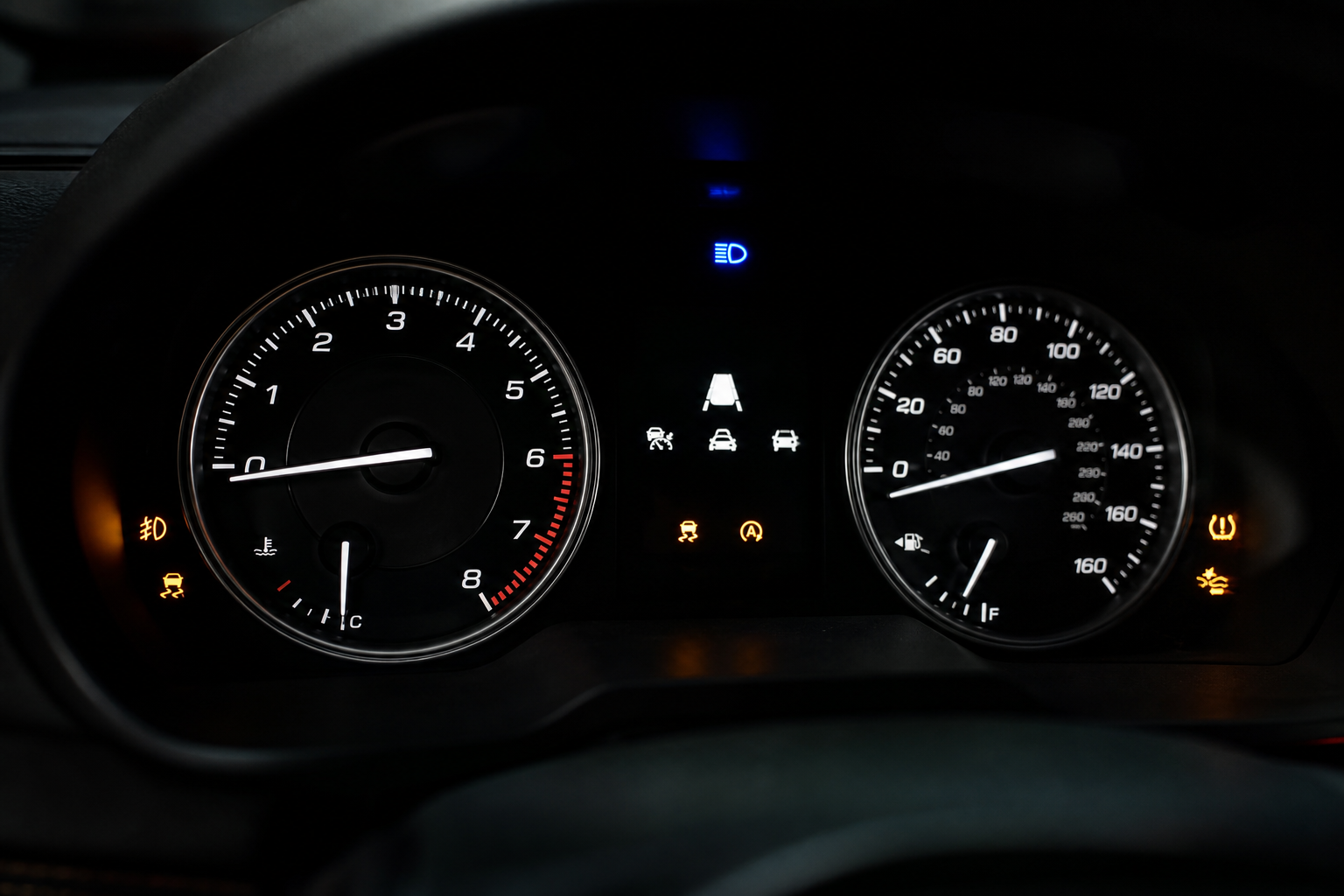 Illuminated dashboard indicator lights on a Subaru Outback instrument cluster at night