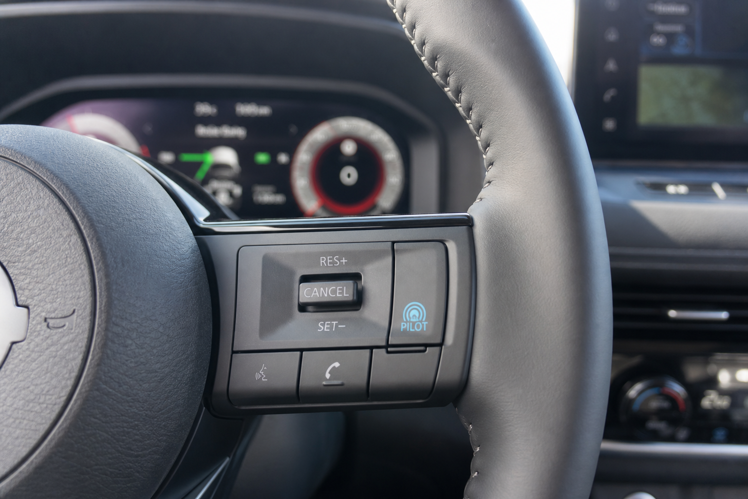 Close-up of Nissan Rogue steering wheel controls with ProPILOT Assist button