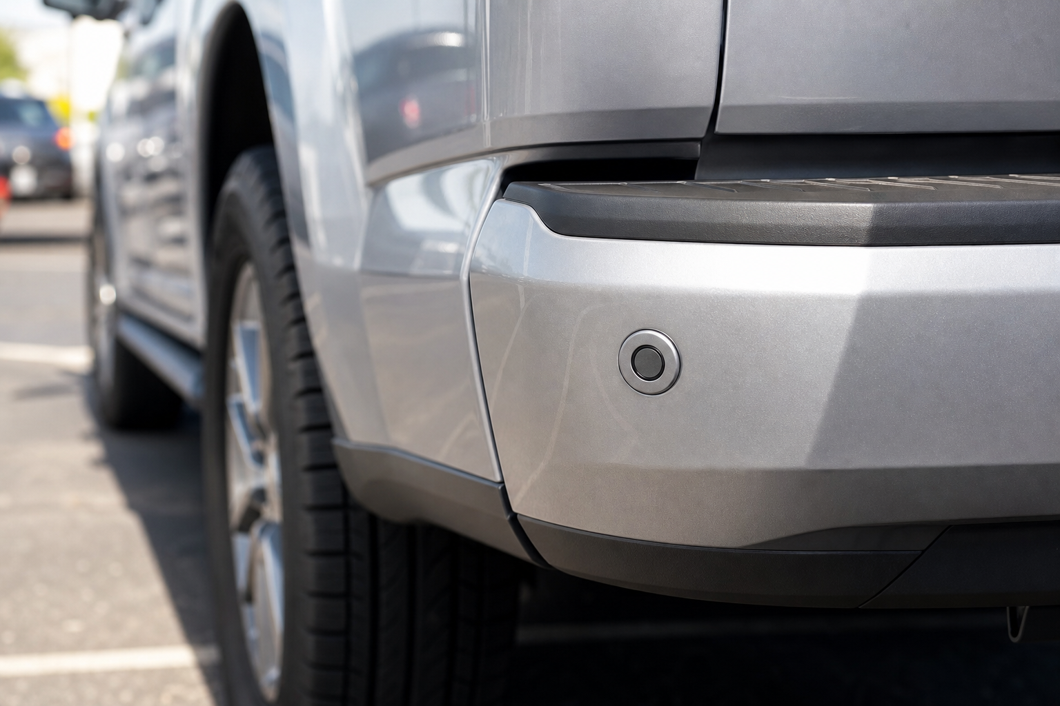 Close-up of a Ford F-150 rear bumper showing the blind spot monitoring sensor location