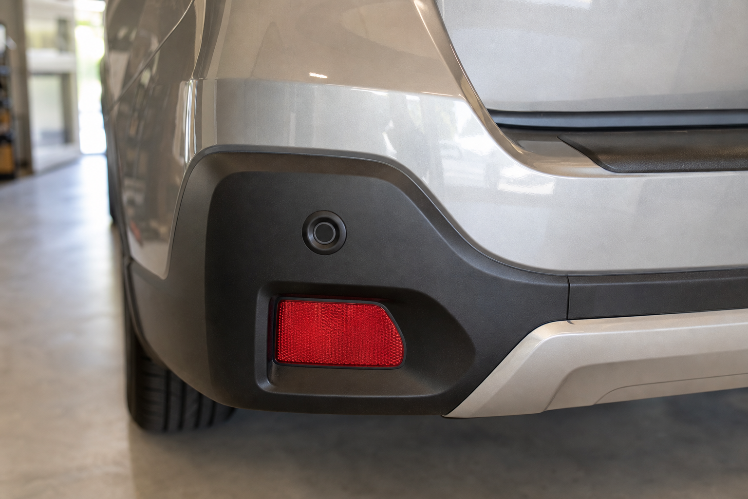 Close-up of Subaru Outback rear bumper showing blind spot monitoring sensor location