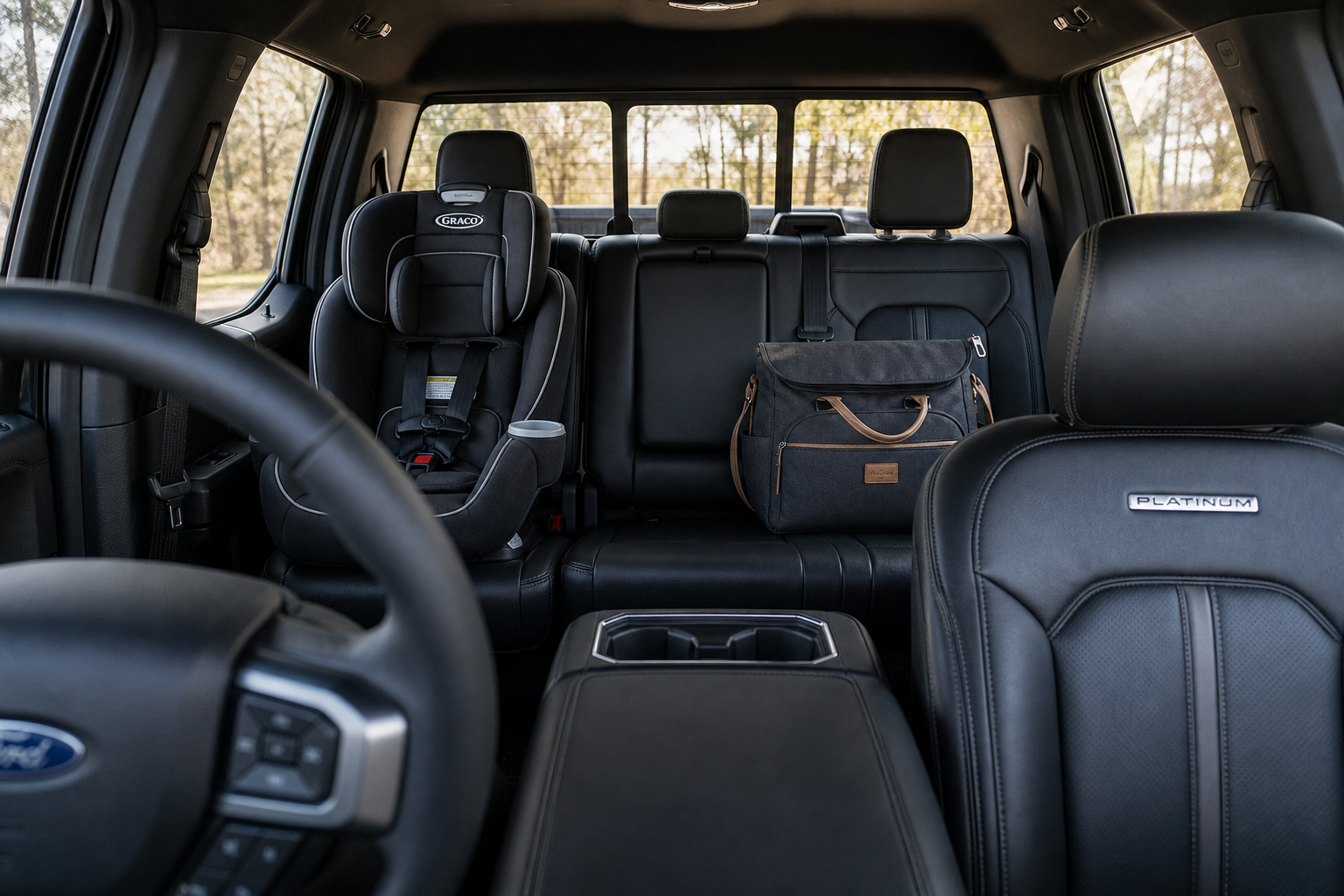 Interior of a Ford F-150 showing rear seats with a child car seat, illustrating what can trigger the rear occupant alert