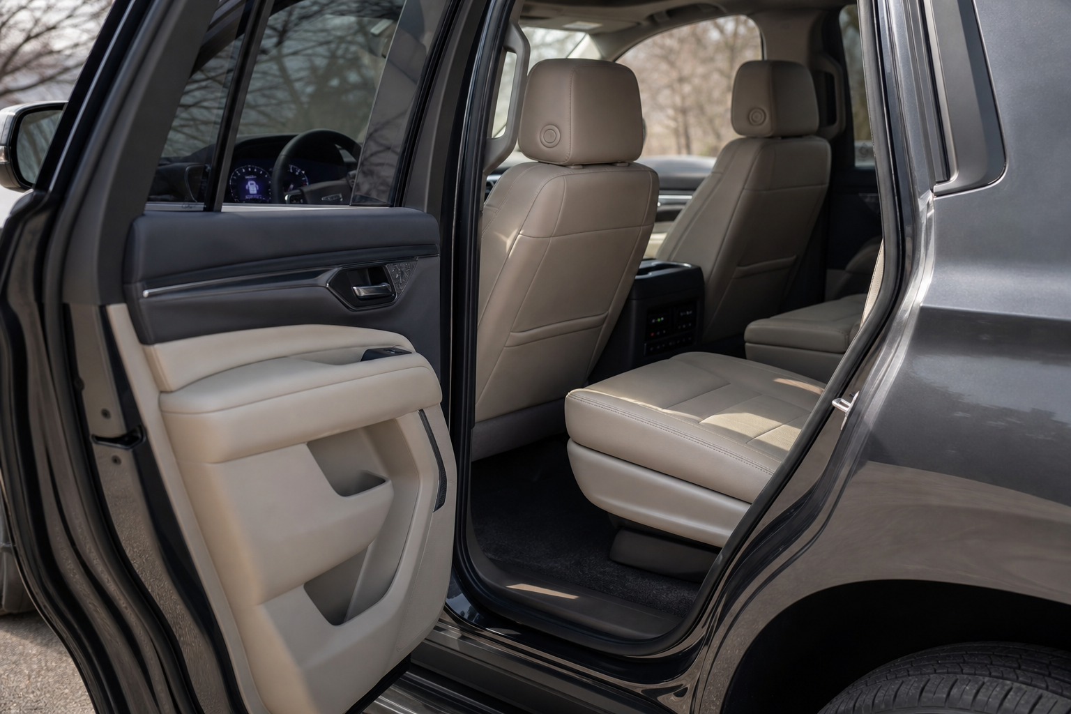 Rear door of a Chevy Tahoe open, showing the back seat that triggers the rear seat reminder system