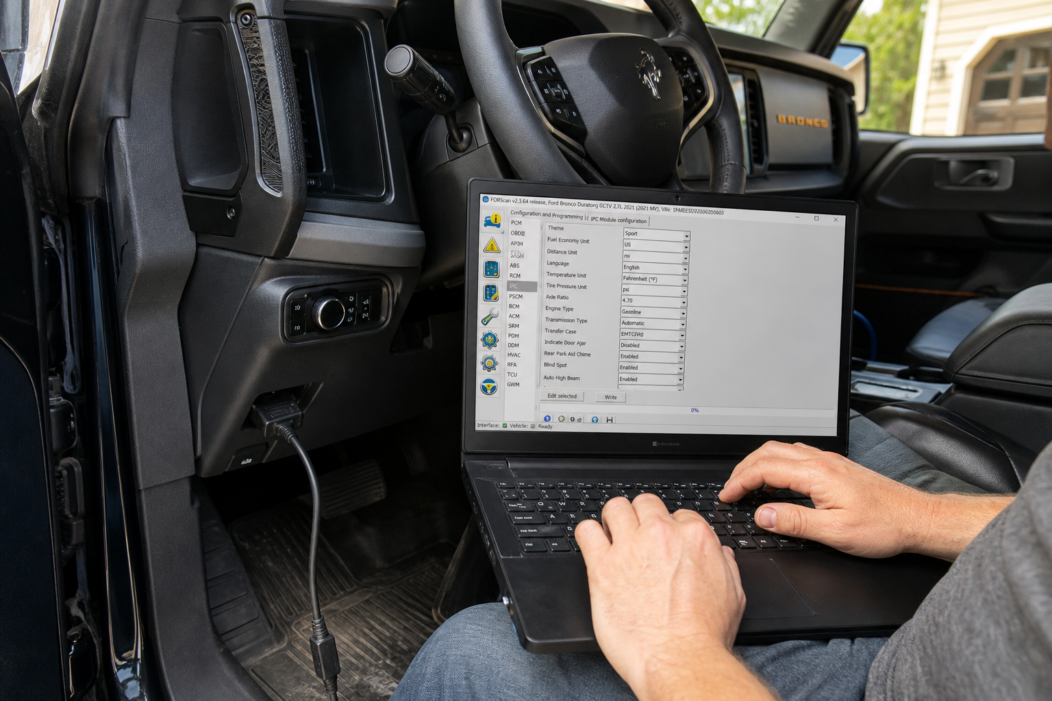 Laptop connected to Ford Bronco OBD port running diagnostic software