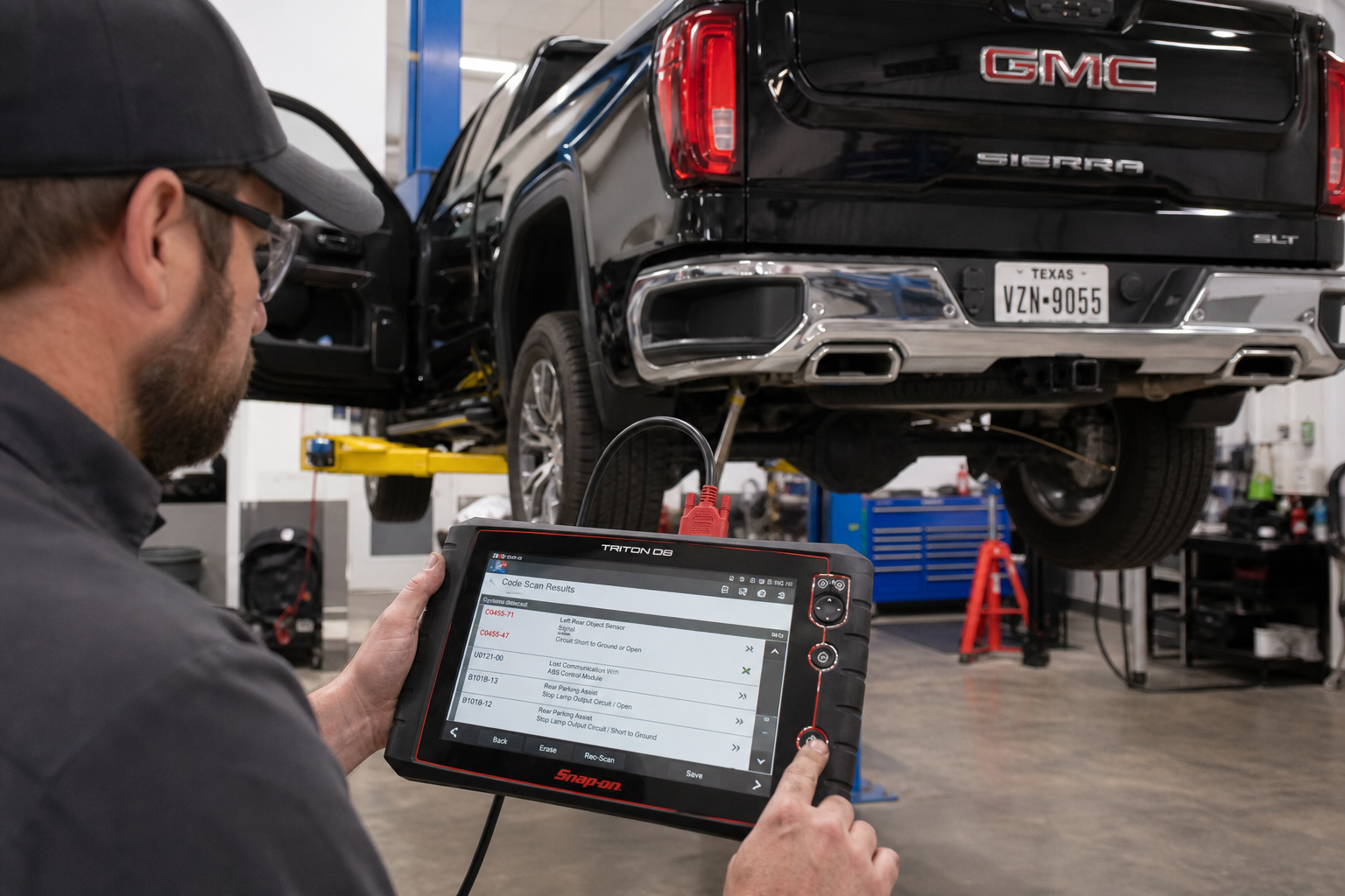 Technician diagnosing blind spot sensor calibration issue on GMC Sierra 1500